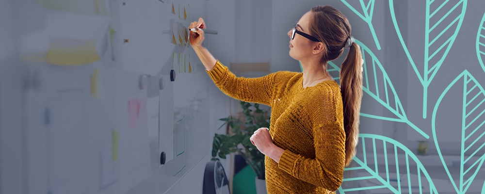 Woman writing on a white board
