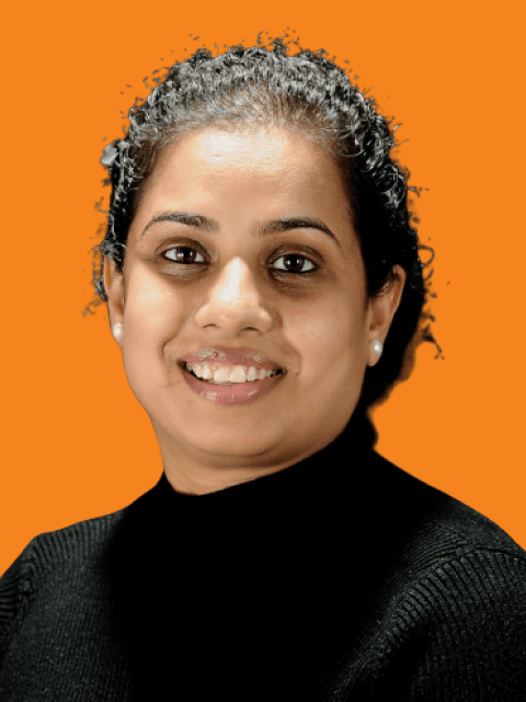 Minimalist profile shot of a man with long braids and a white shirt, set against a soft, light background.