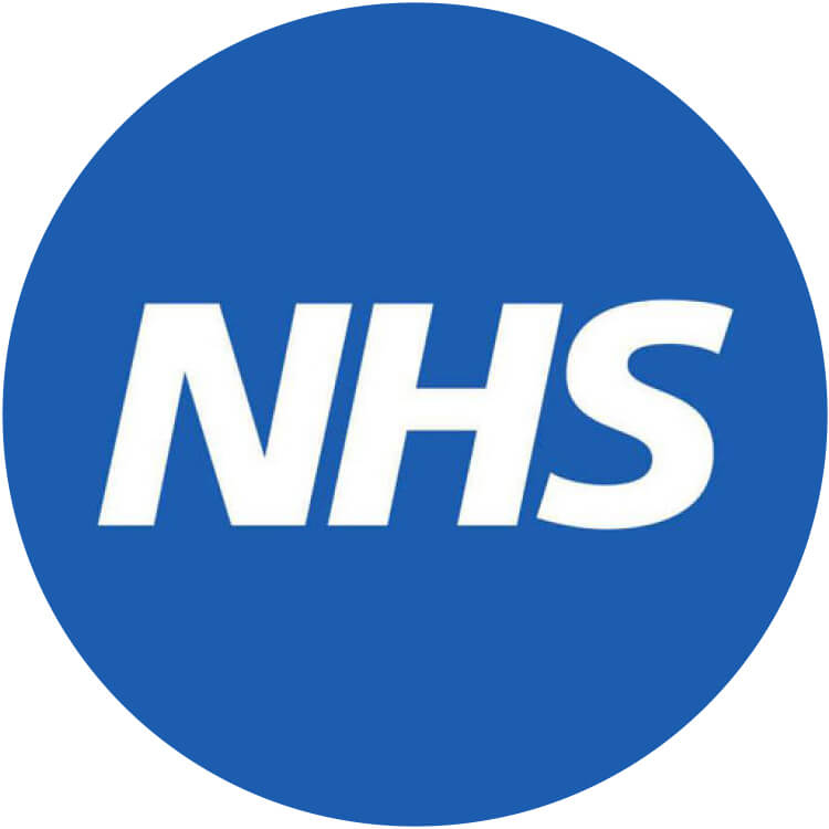 smiling man standing near green tree