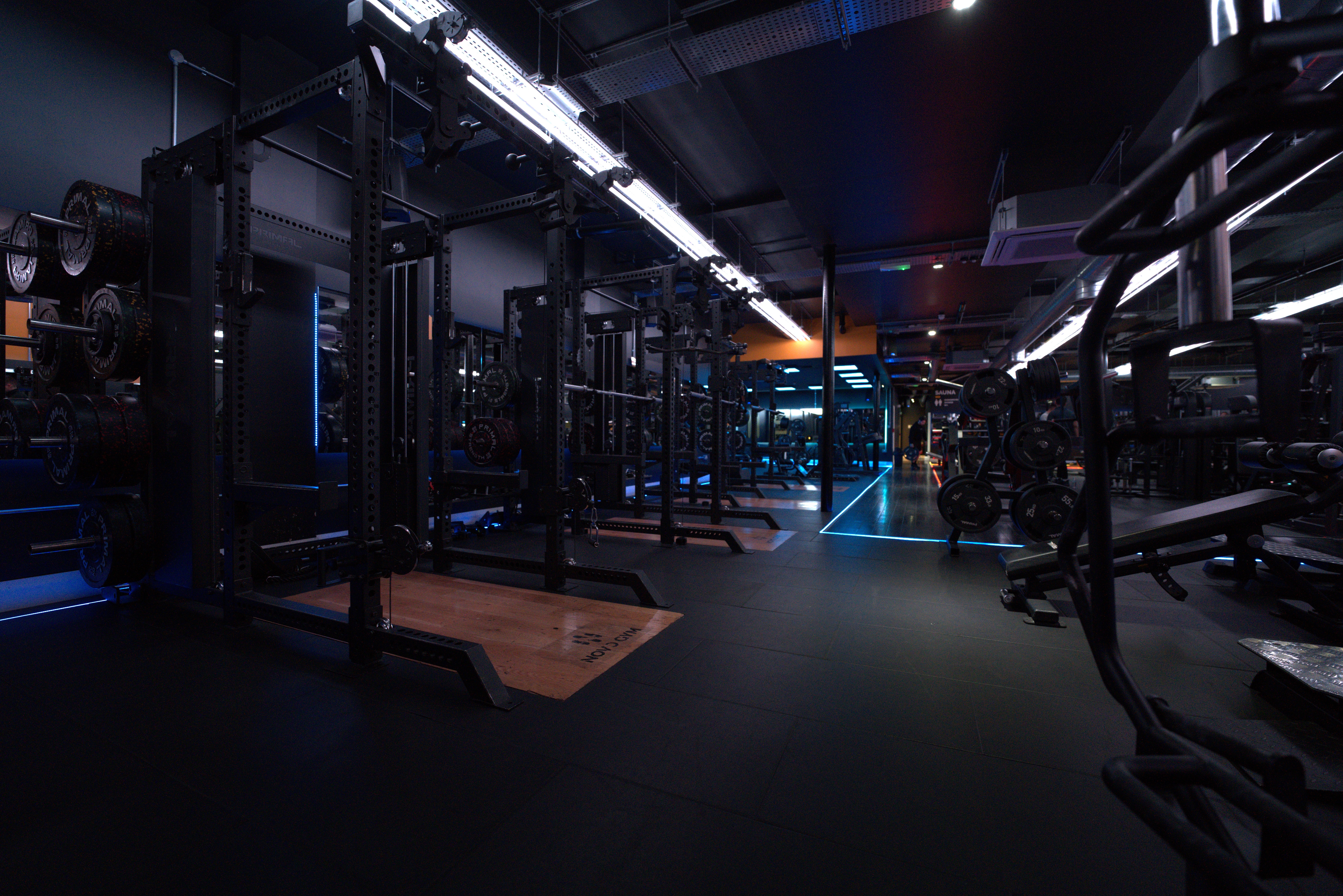 Rachel, personal trainer, looking to the side confidently in a fitness studio