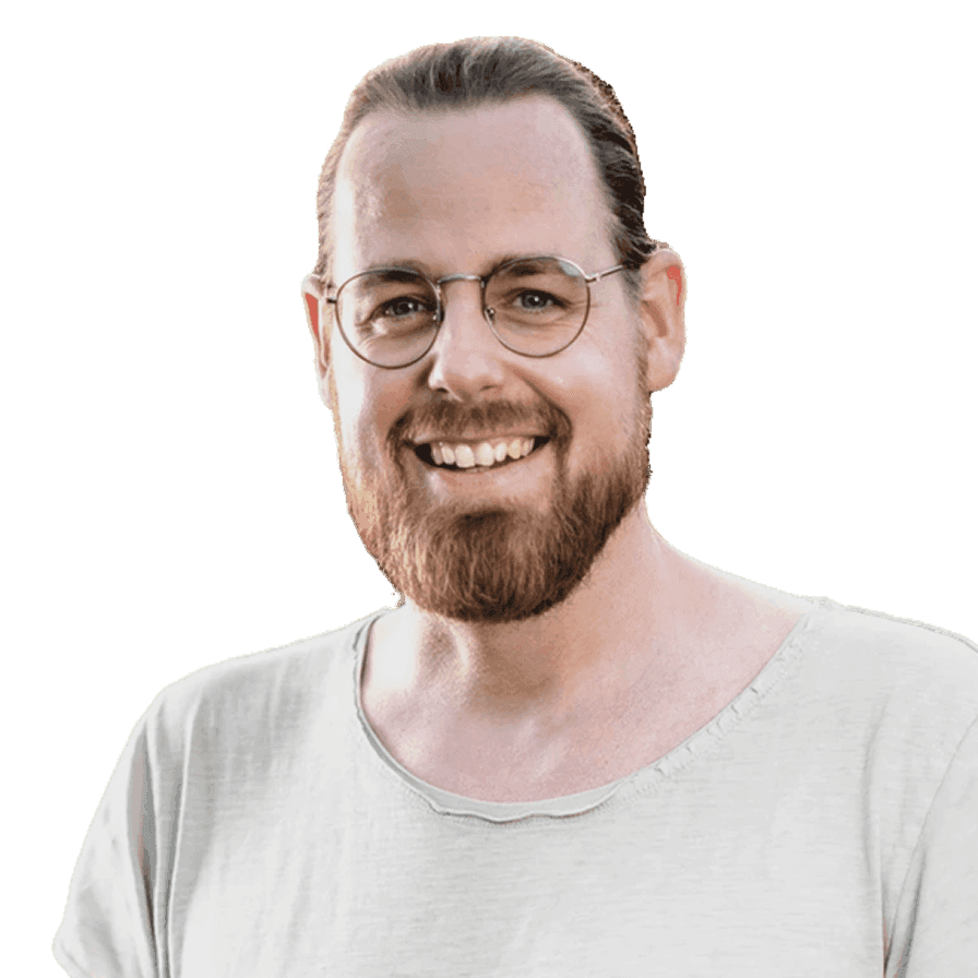 Man with round glasses and beard, smiling