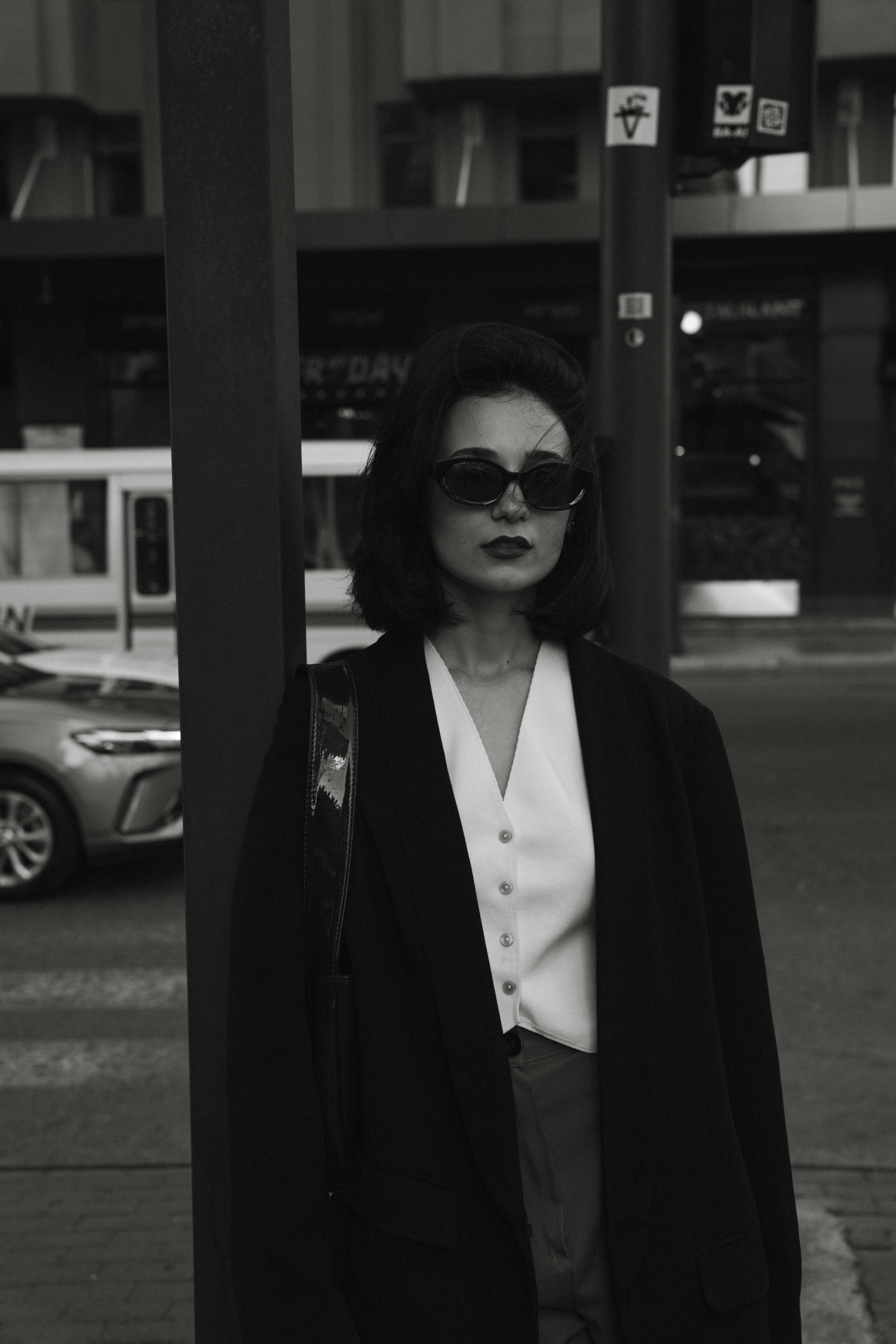 A young man in a white t-shirt stands against a light-colored background.