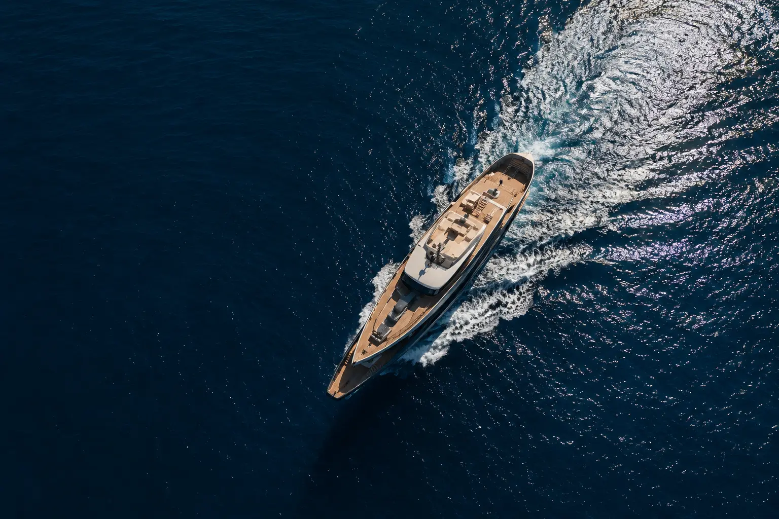 Aerial drone view of a luxury yacht cruising across the Mediterranean Sea on la Côte d’Azur.
