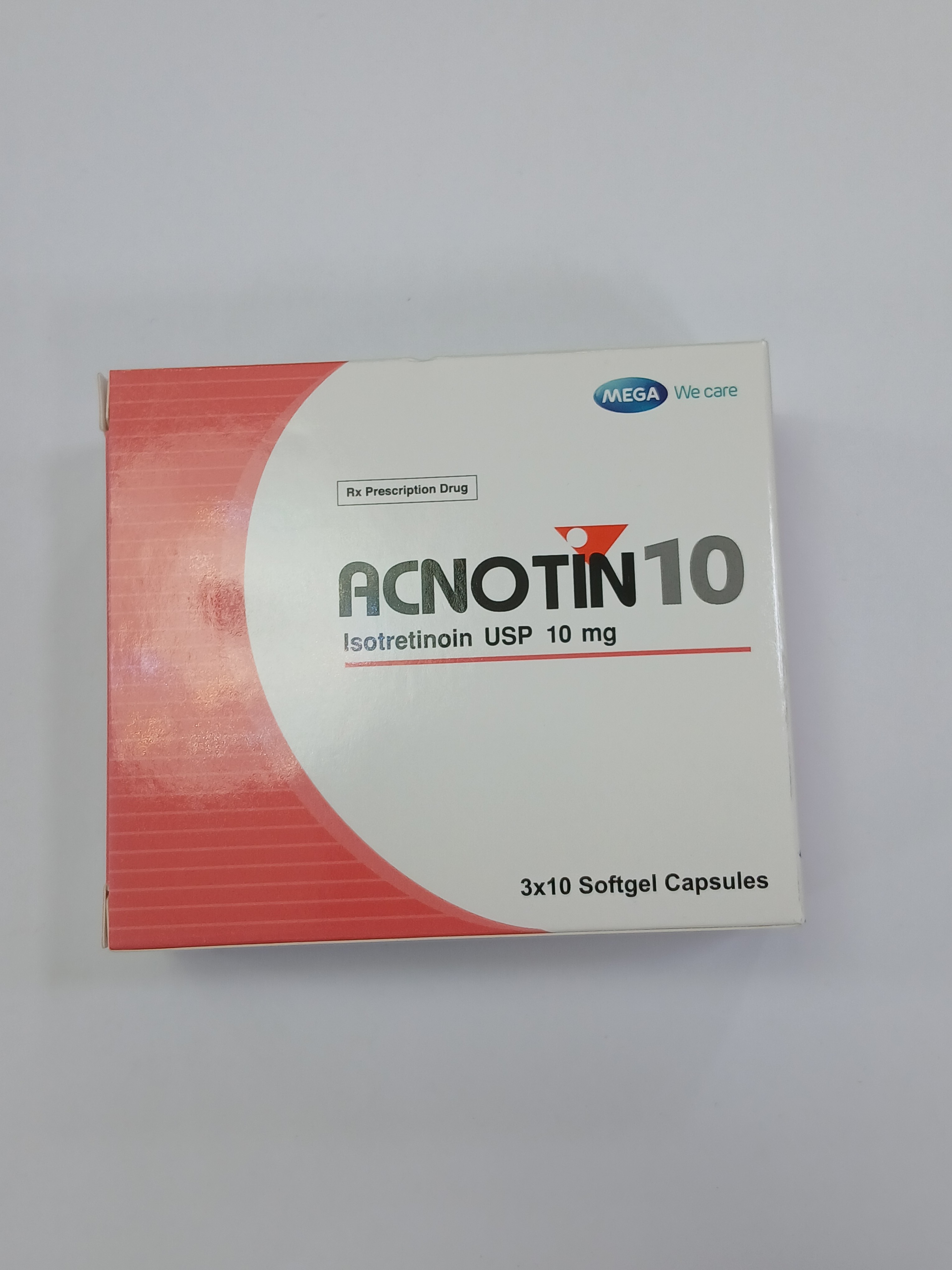 A white and red cardboard box for medication is angled on a light gray surface, displaying the text "ACNOTIN 10" and "Isotretinoin USP 10 mg" on its front.