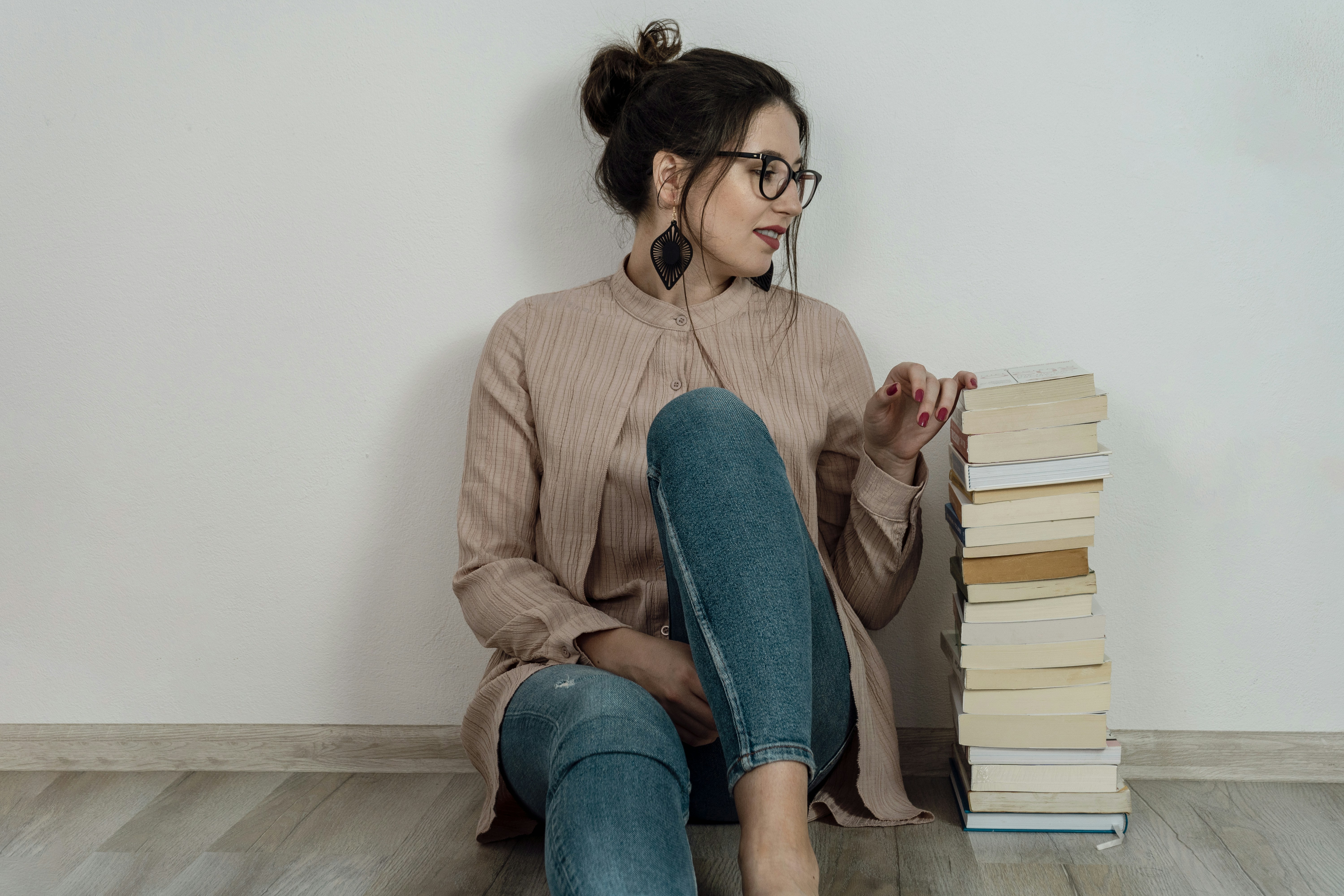 woman with a bunch of books - Glow Up Book