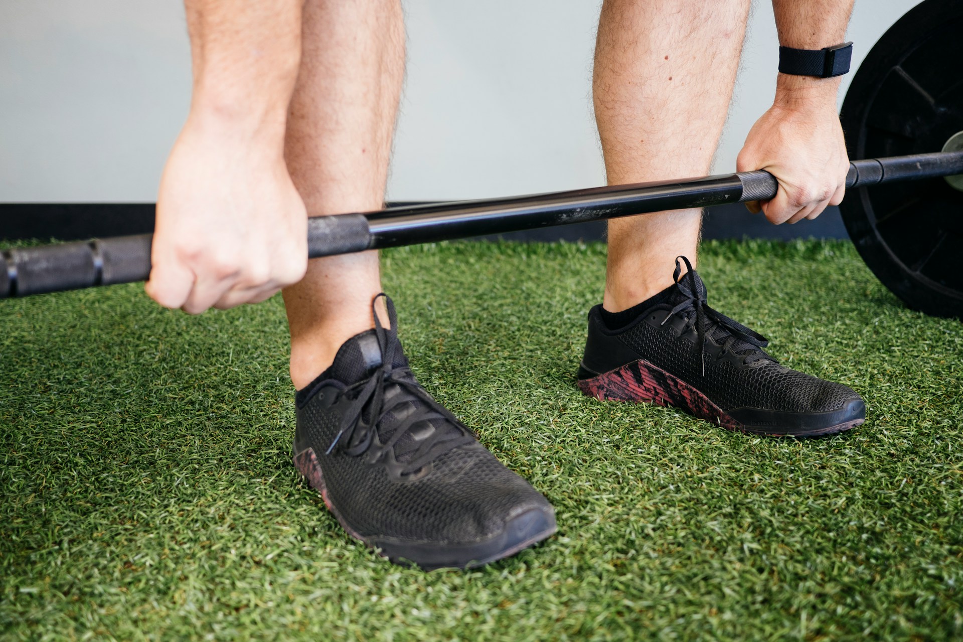 A weightlifter's feet and arms.