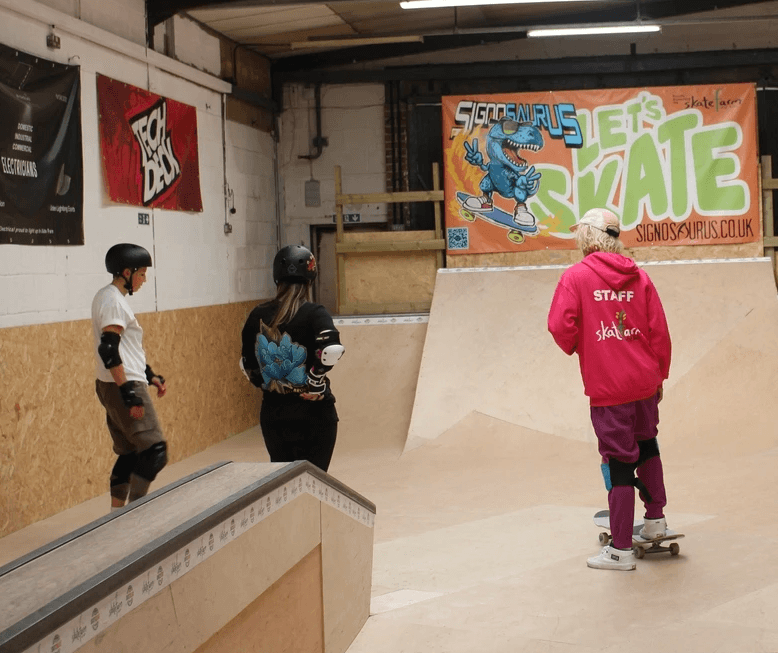 Adults learning to skateboard at The Skate Farm indoor skatepark in Haywards Heath