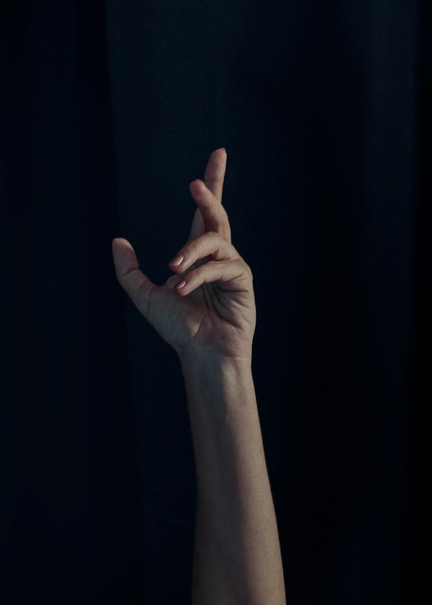 Dancer captured mid performance with artistic and expressive movements against a dark background.