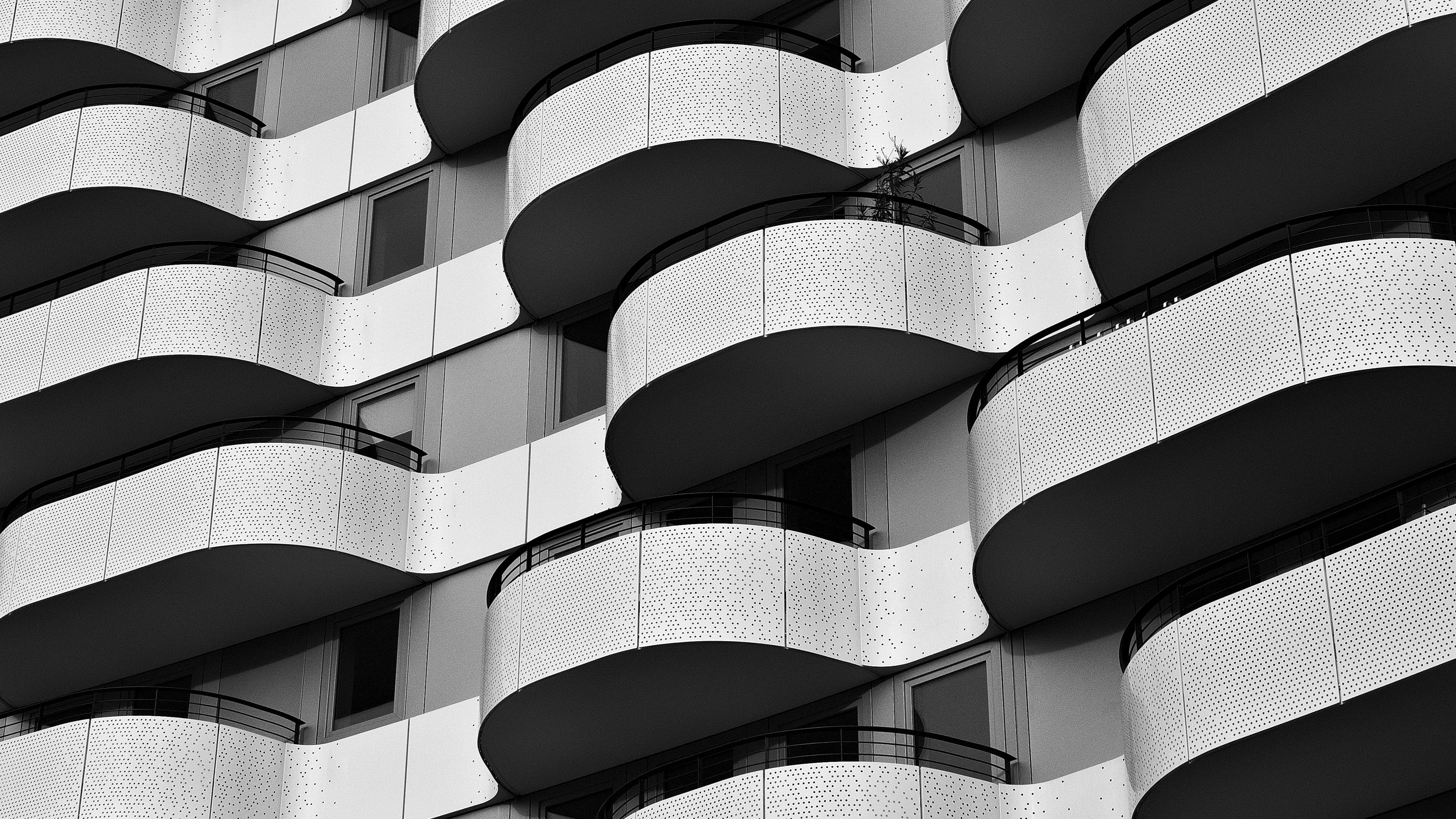 a black and white photo of a building with balconies