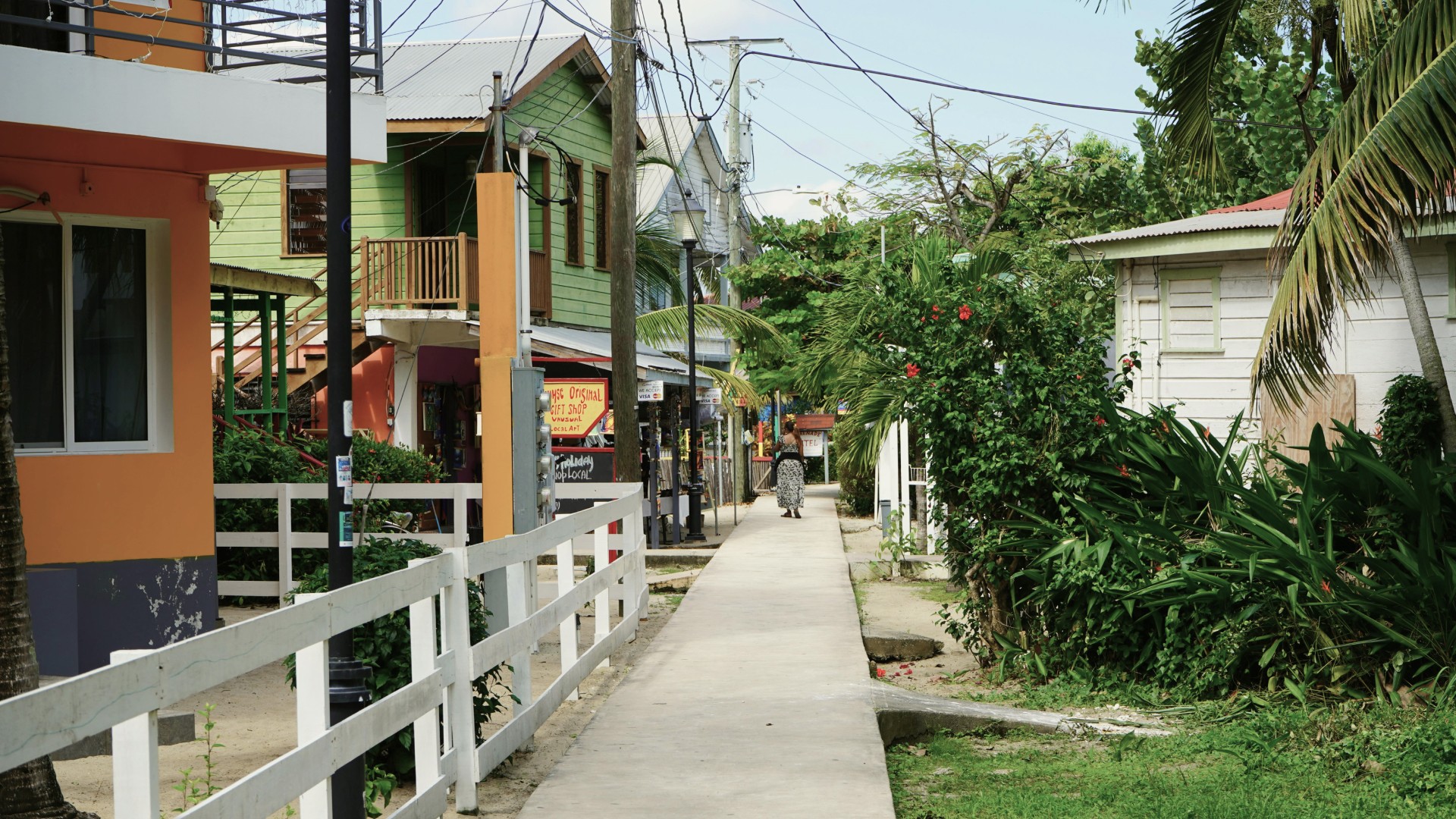 A narrow steet with colorful houses just off the beach in Placencia, Belize