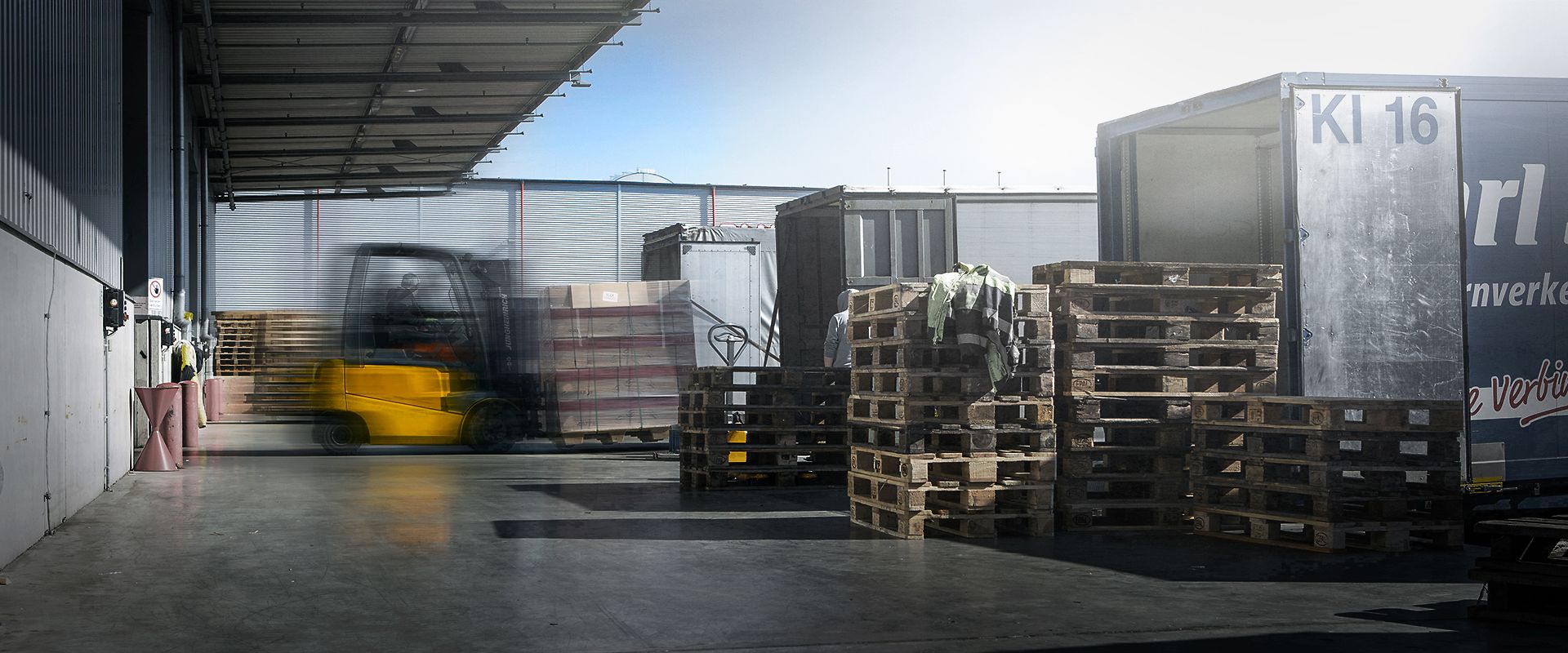 Two cheerful men laughing in the front seats of a sportscar, great for car rental joy promotions.