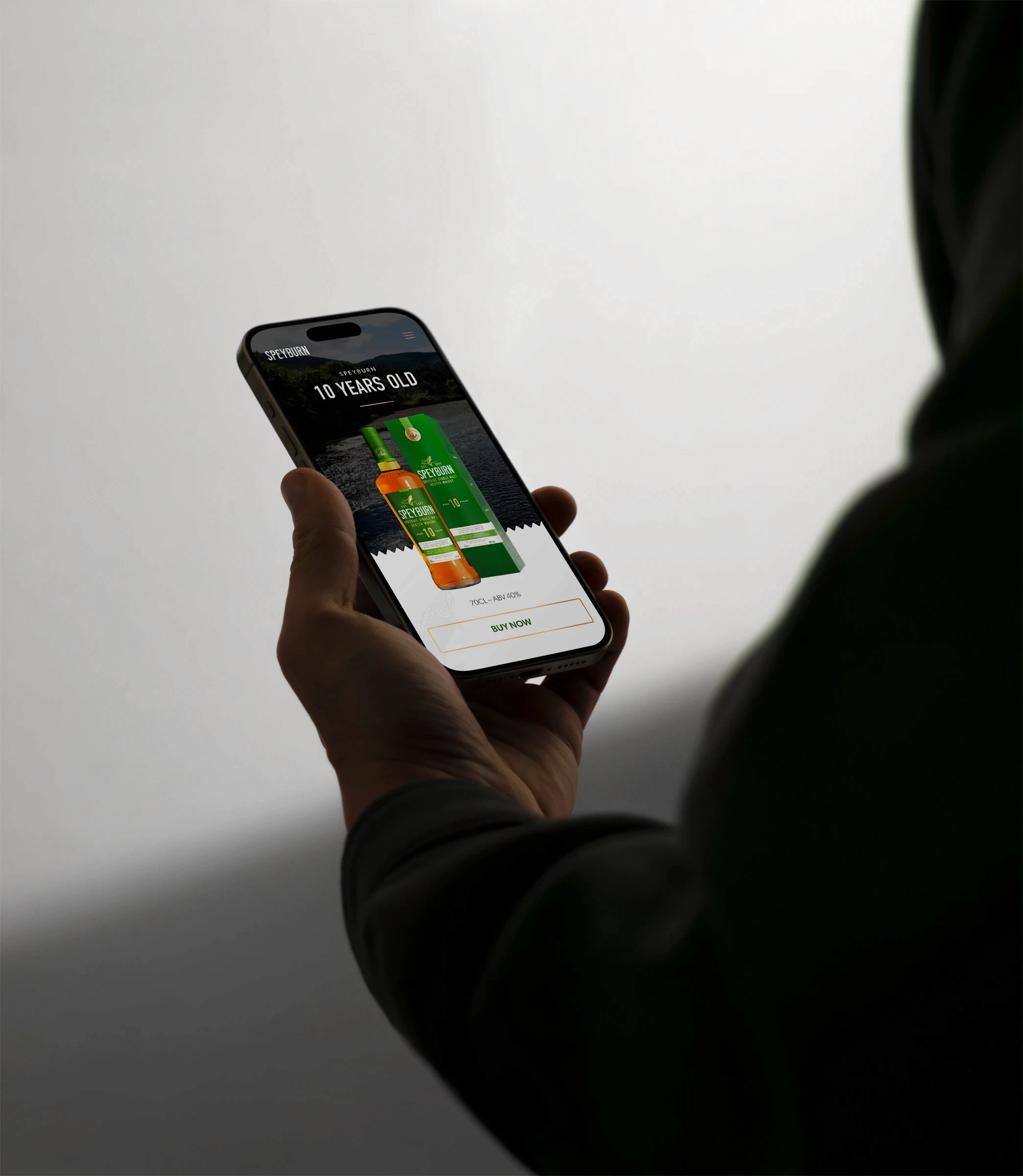 Man holding mobile phone with Speyburn Whisky 10 Year Old product page