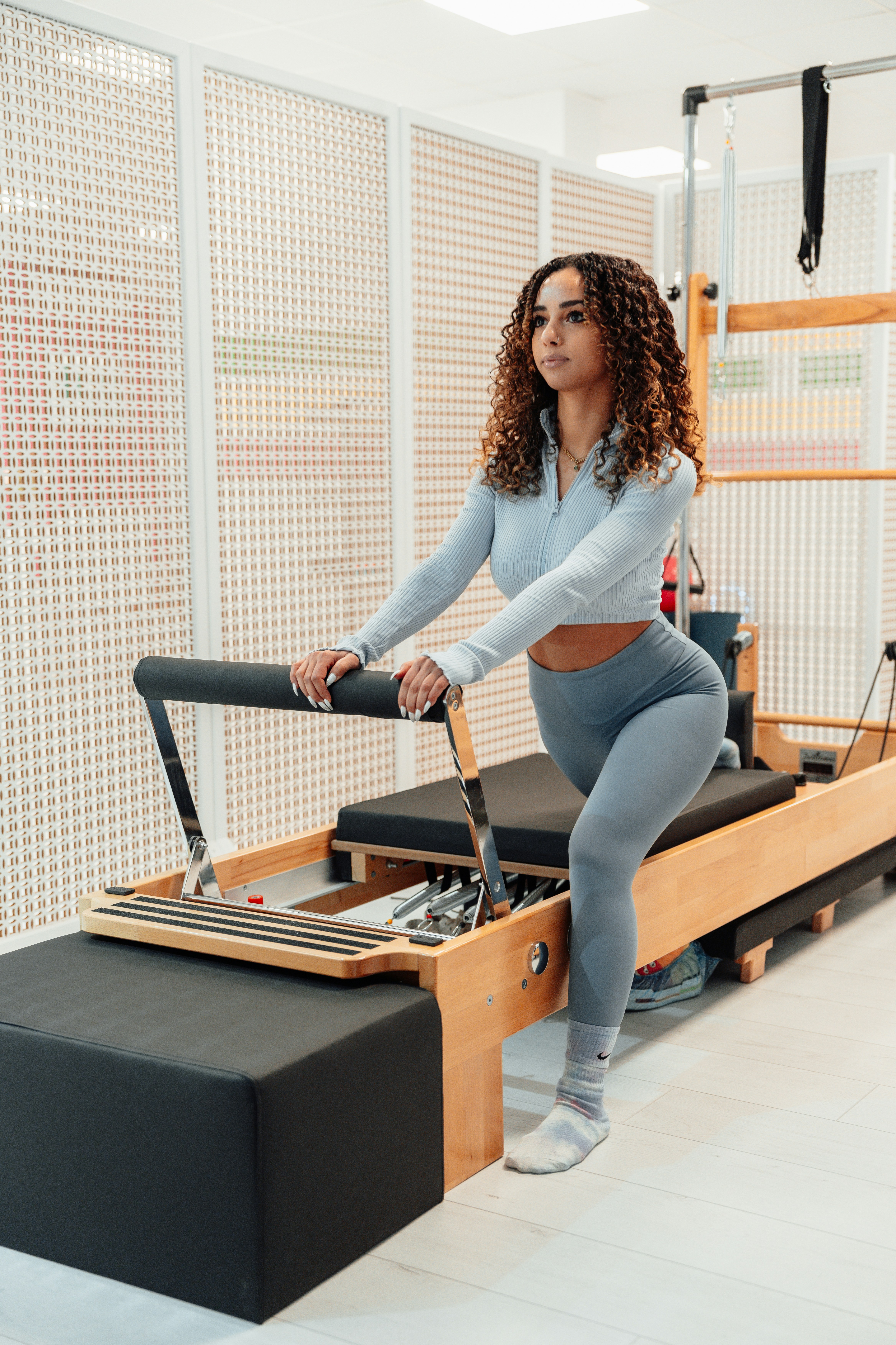 a woman on a pilates reformer machine
