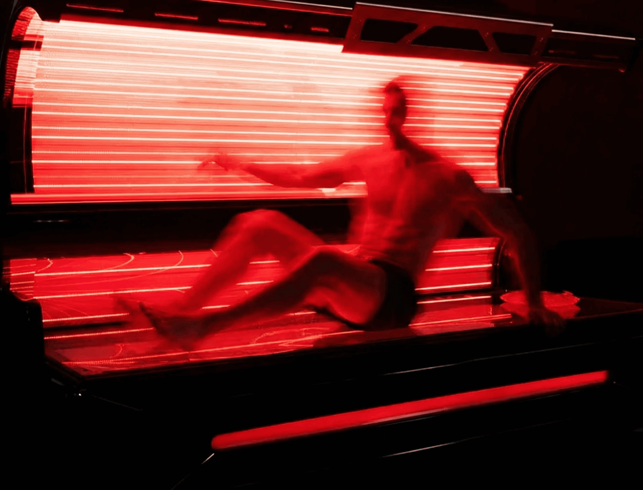 Man in a Red light therapy bed