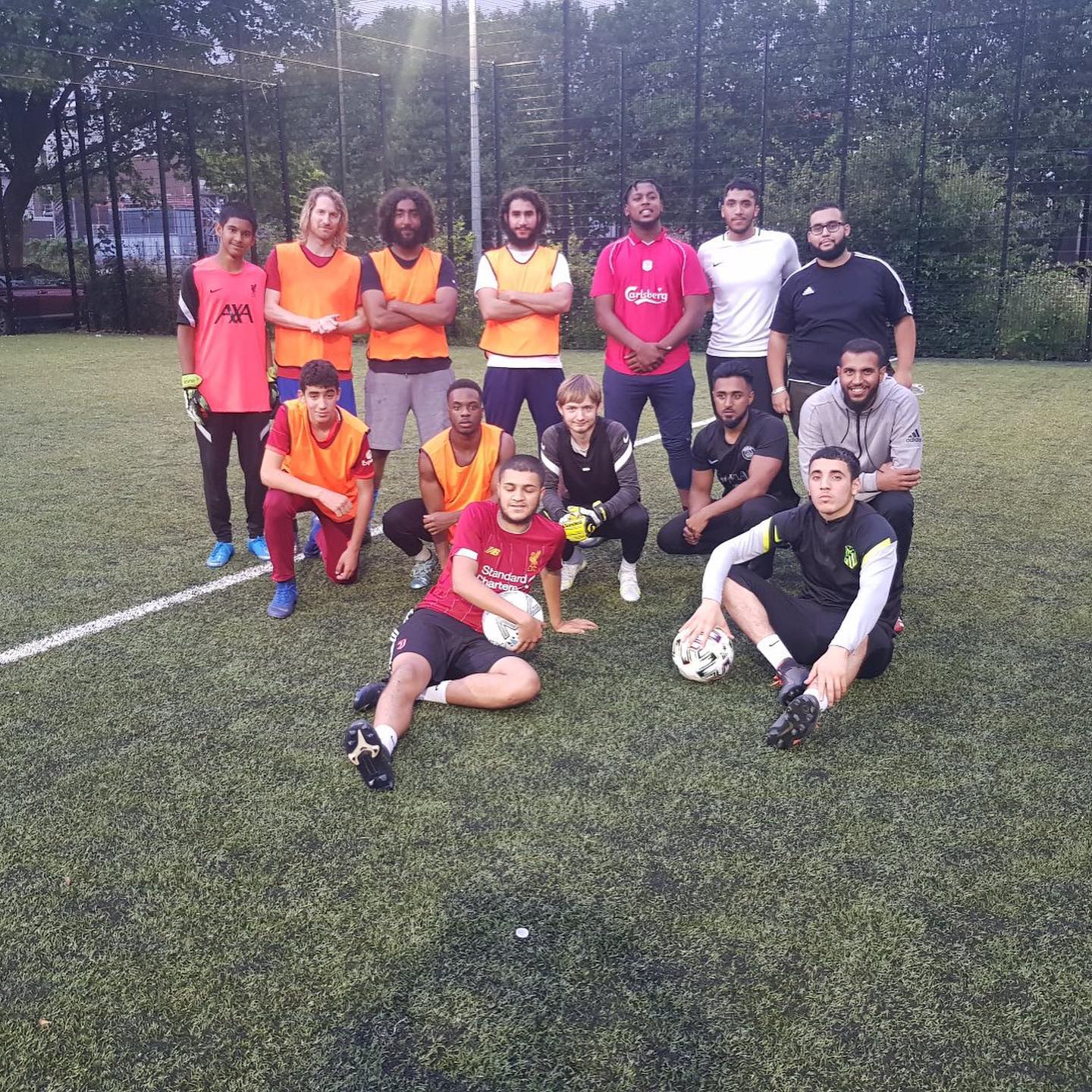 Young people posing for a group photo ona football pitch at our Euro legacy football tournament