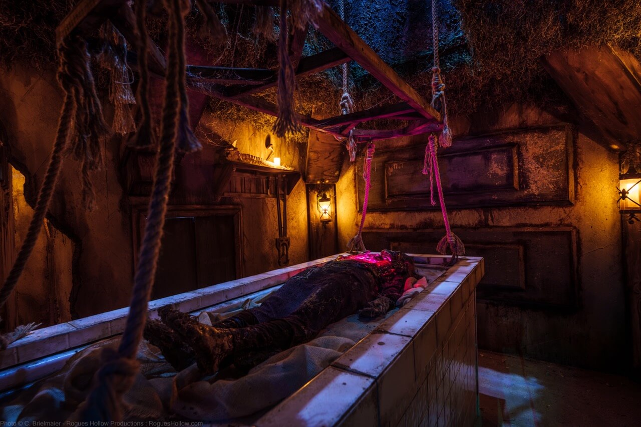 Haunted room with a covered body on a tiled table