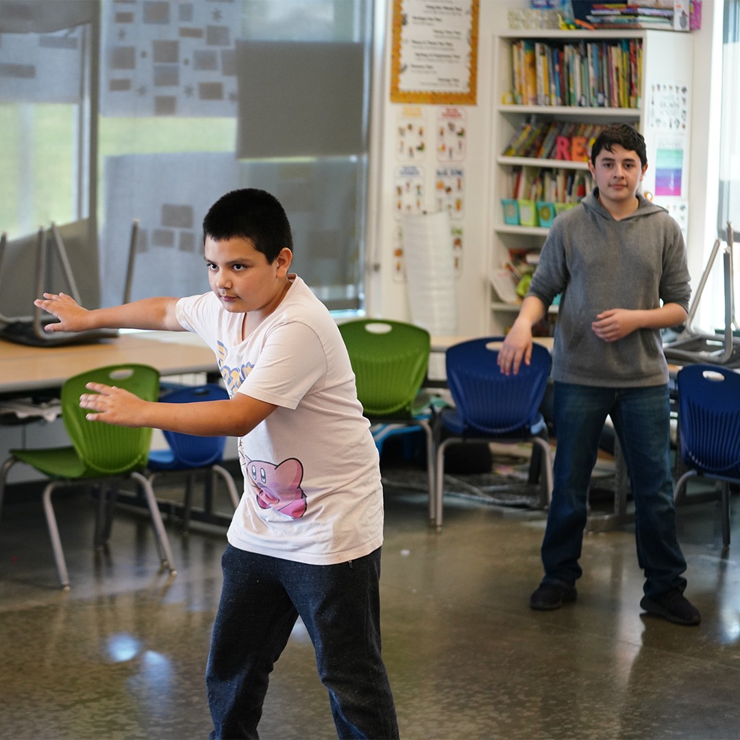 Dance instructor teaching foundational hip hop techniques to students