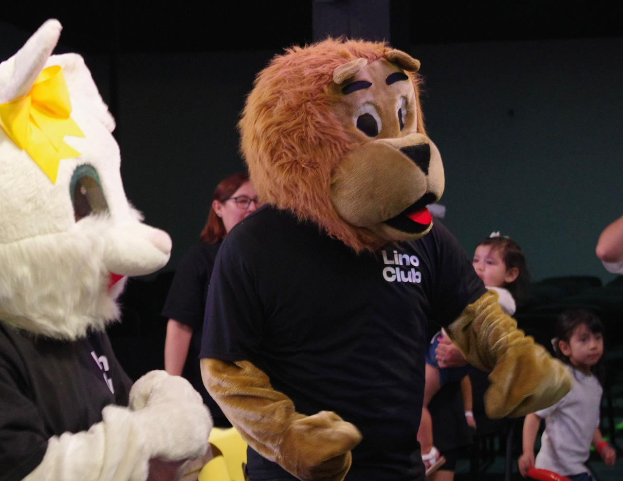 woman in gray coat singing on stage