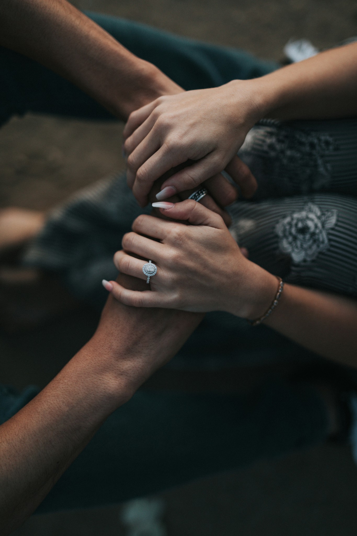 people joining hands and reassuring each other