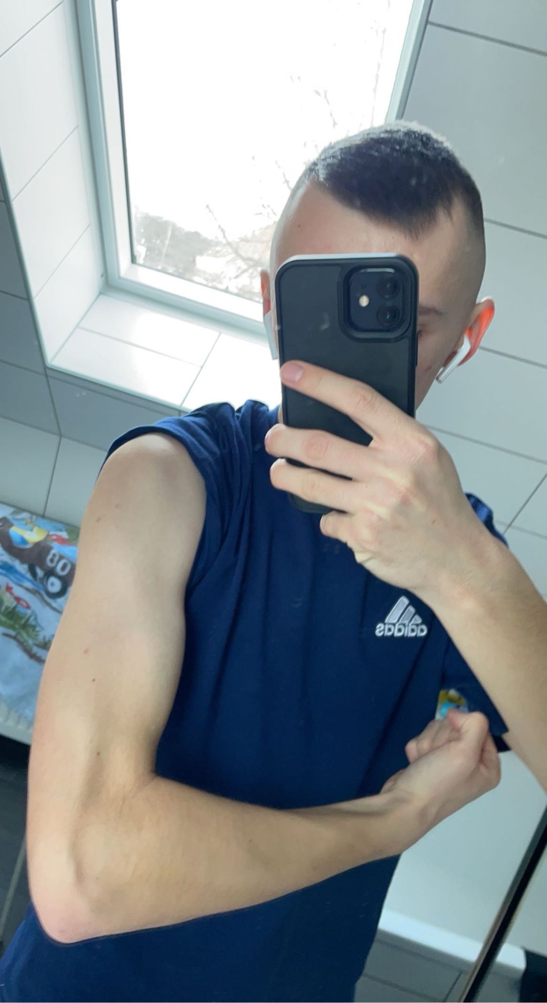 greyscale photo of woman in bralette inside room