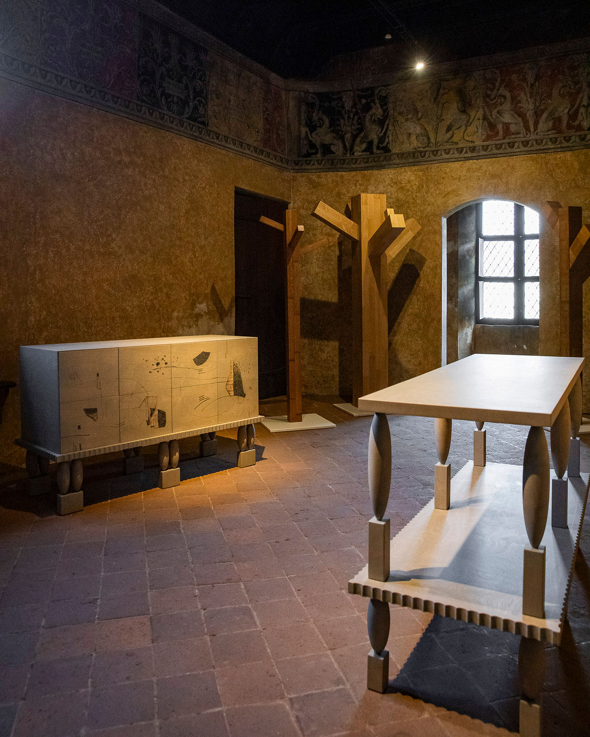 Roots Altar cabinet with designer Jiri Krejcirik posing in exhibition setting at PAD Paris