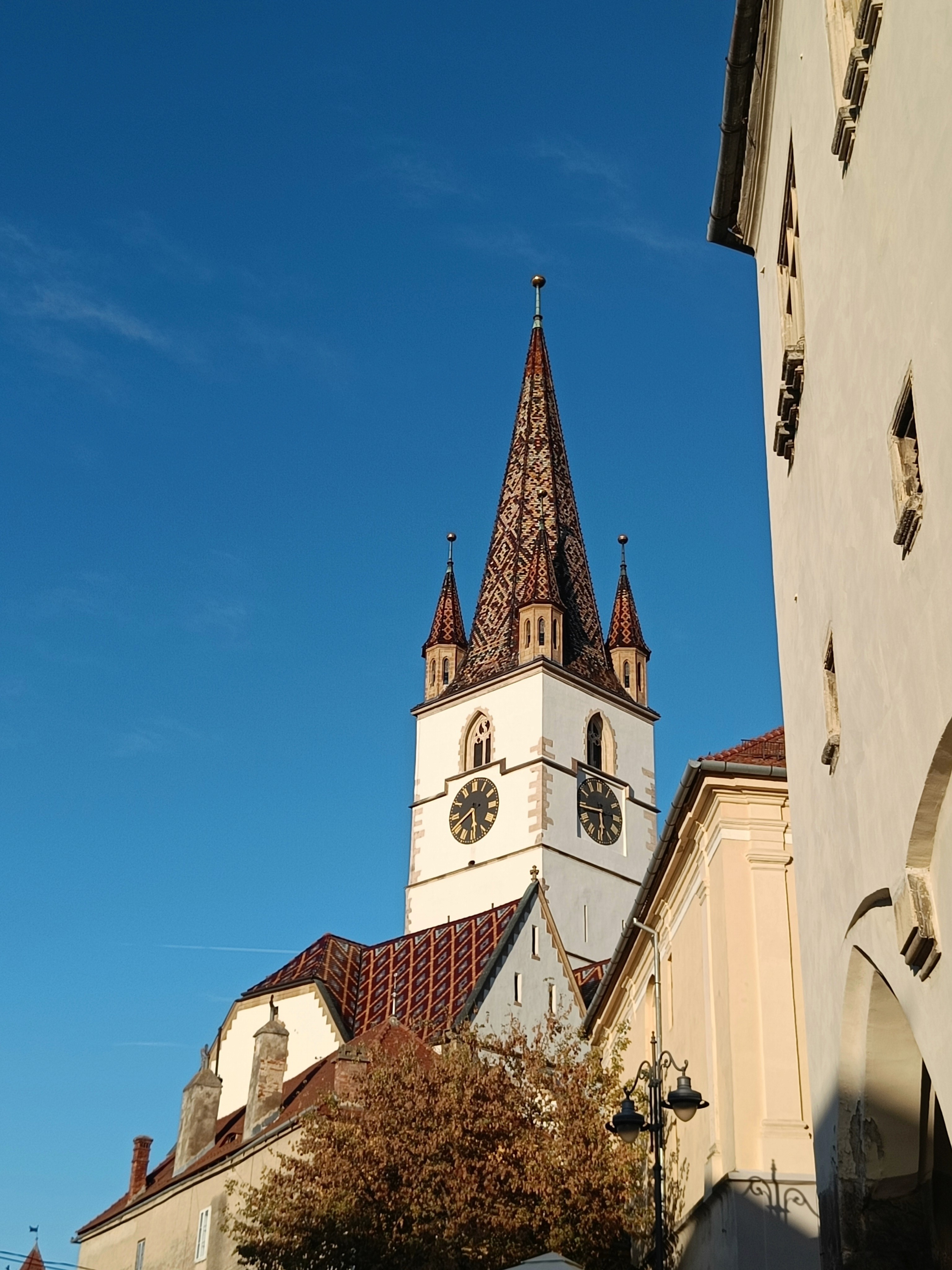 Tall church tower against a blue sky.