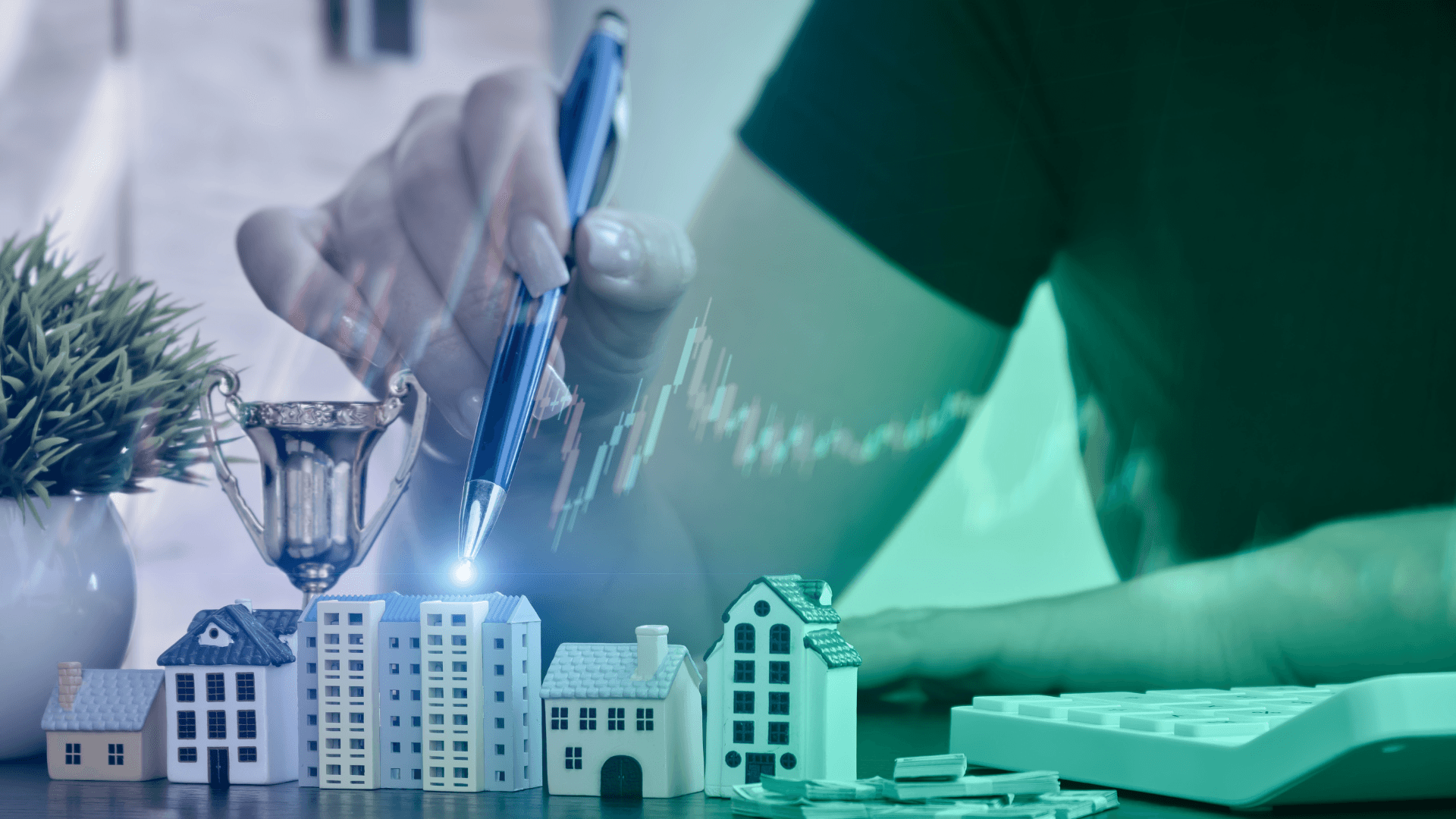 Smiling man sitting at a table with a laptop, phone, and coffee mug, engaged in a video call or online meeting.