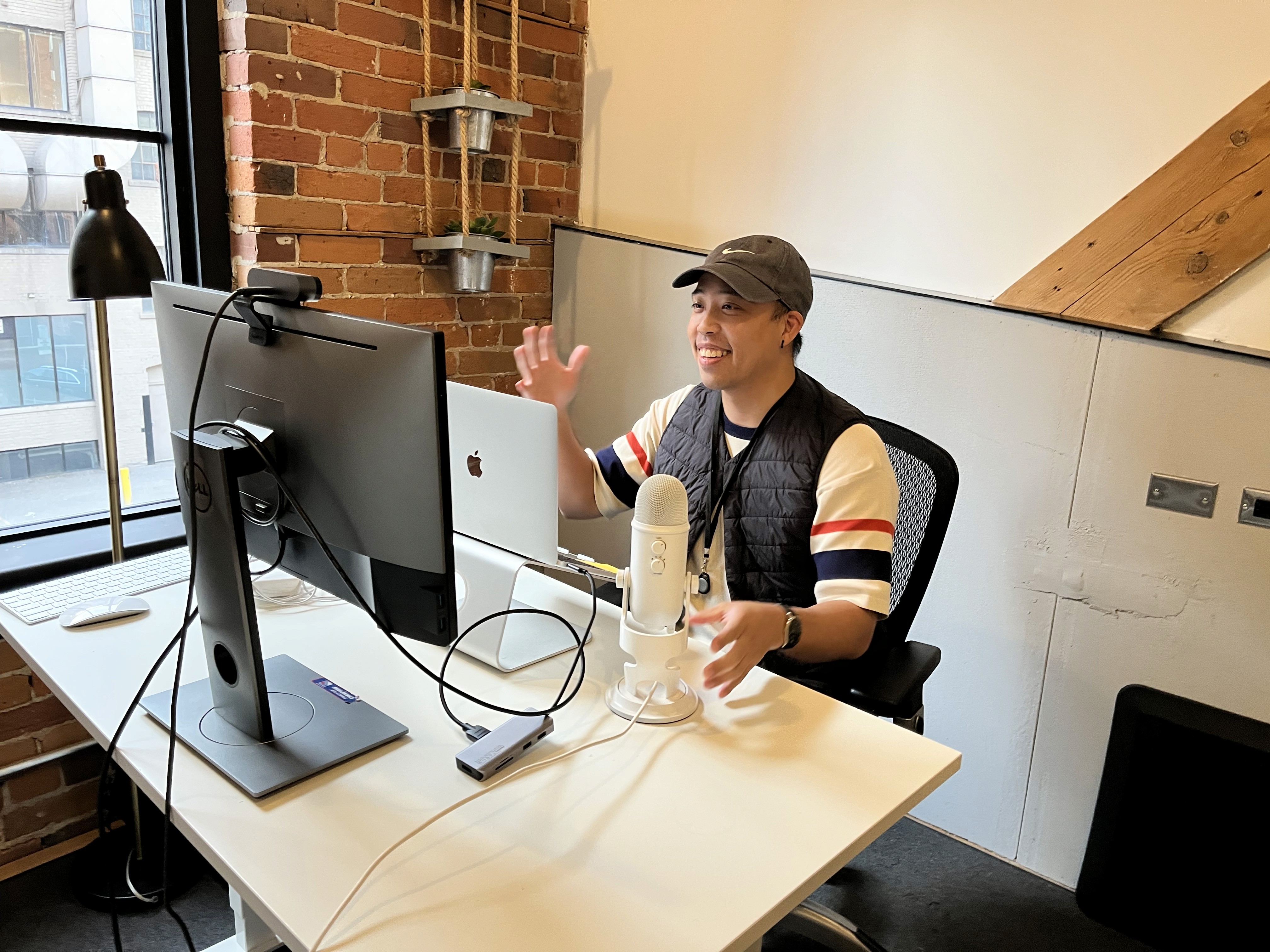 An image of Lester sitting at a desk in front of the computer