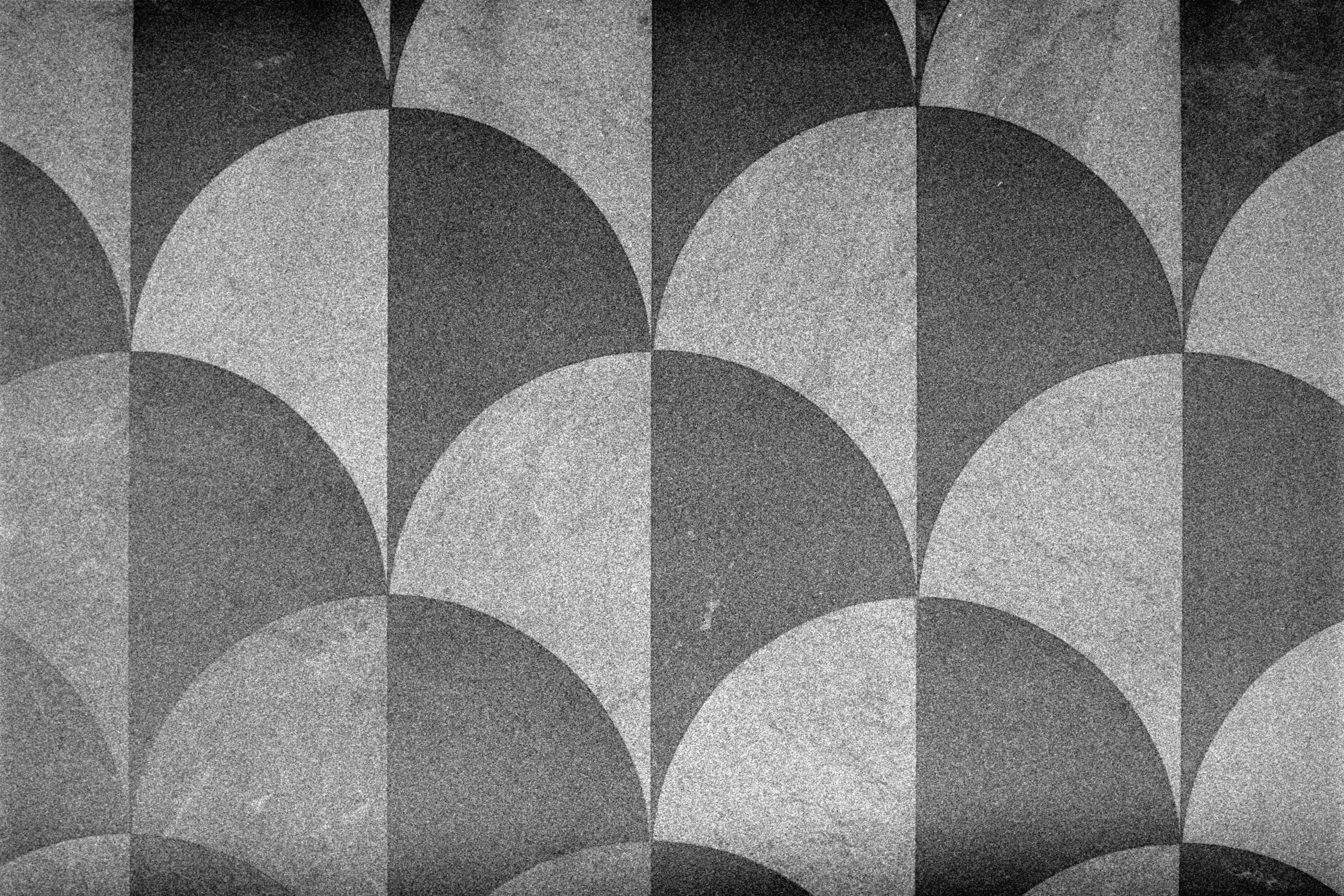 Abstract geometric pattern of semicircles and squares.