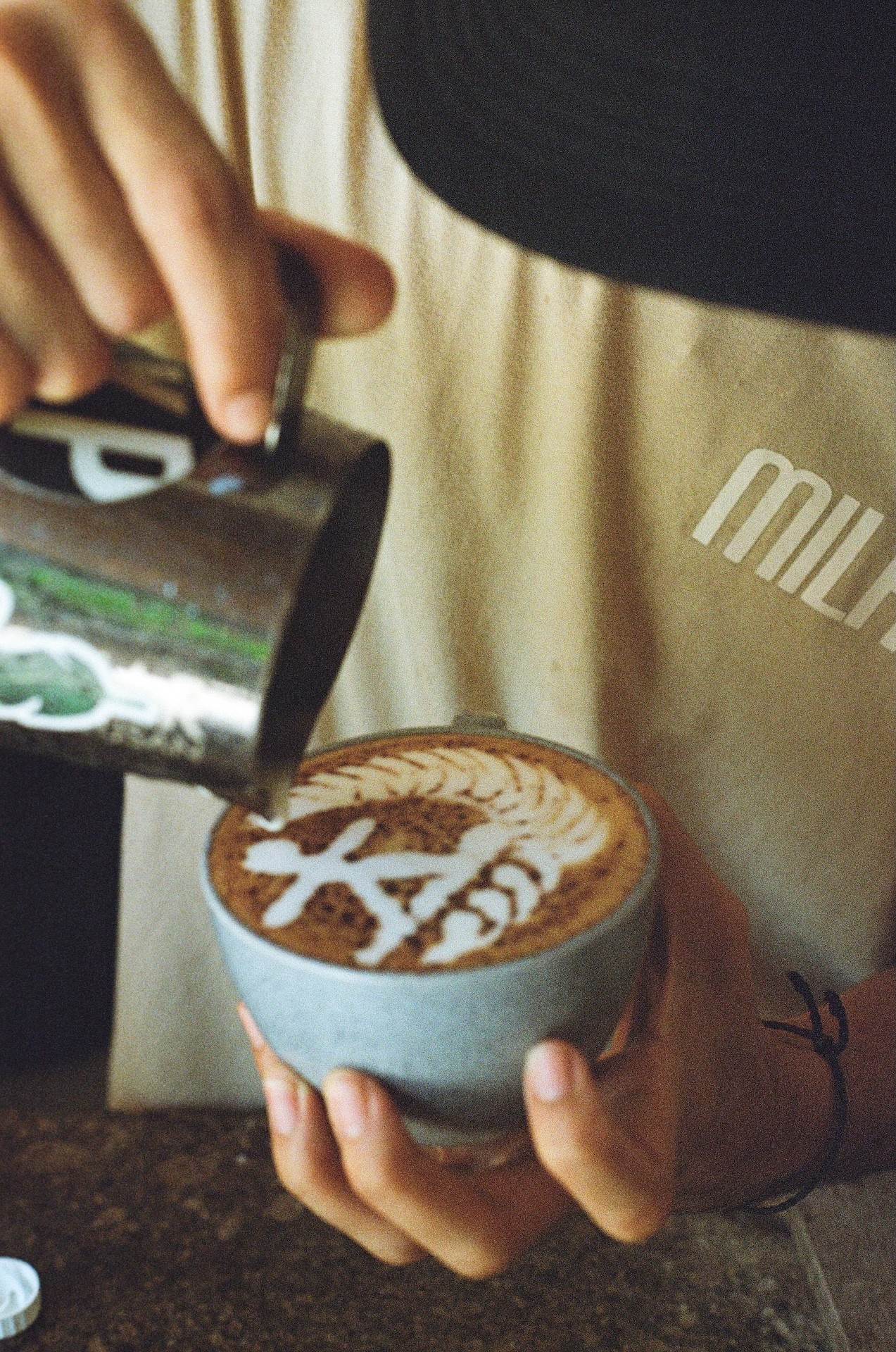 barista making coffee with a surfer