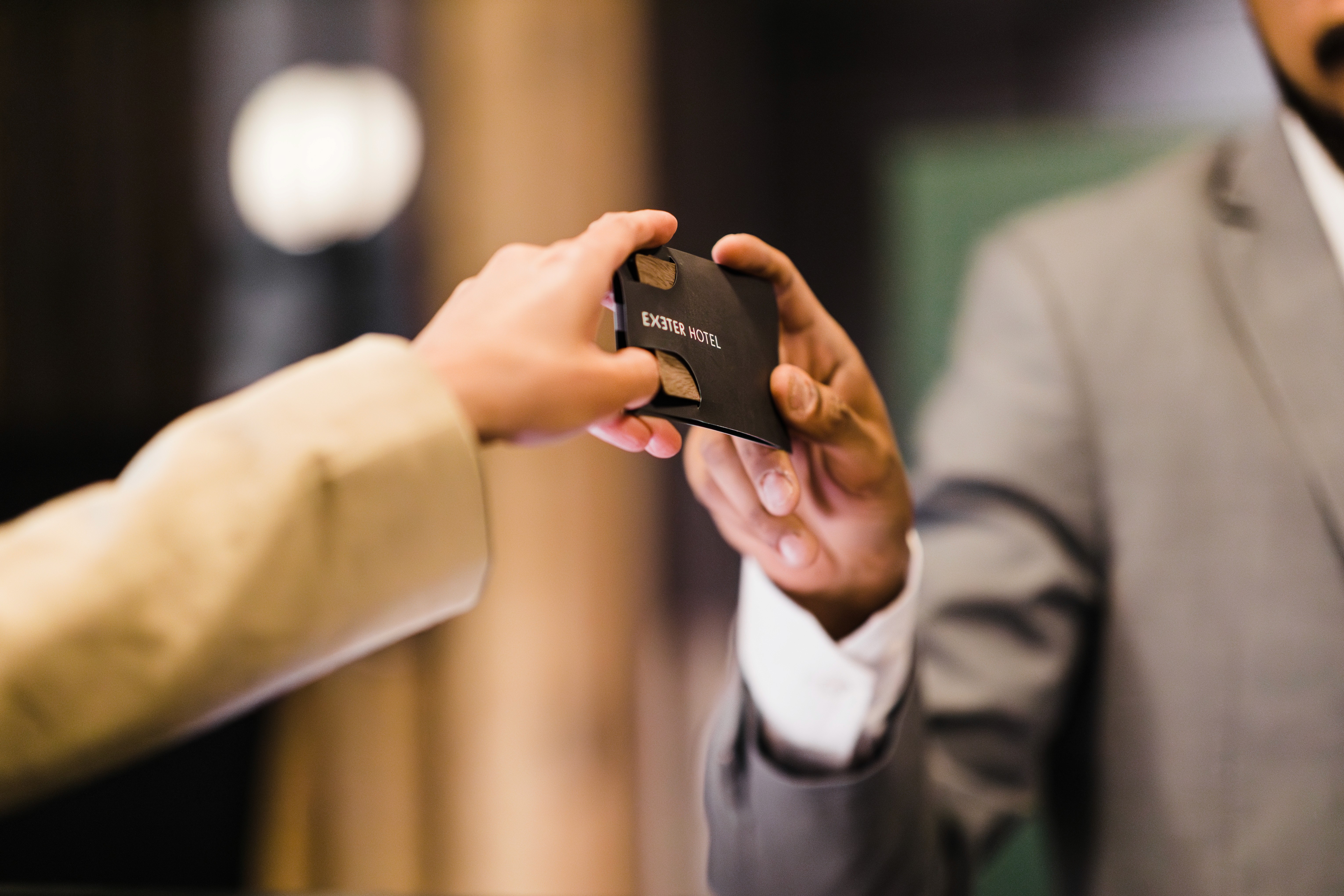 Guest receiving a room key card during check-in at Exeter Hotel in Reykjavík.