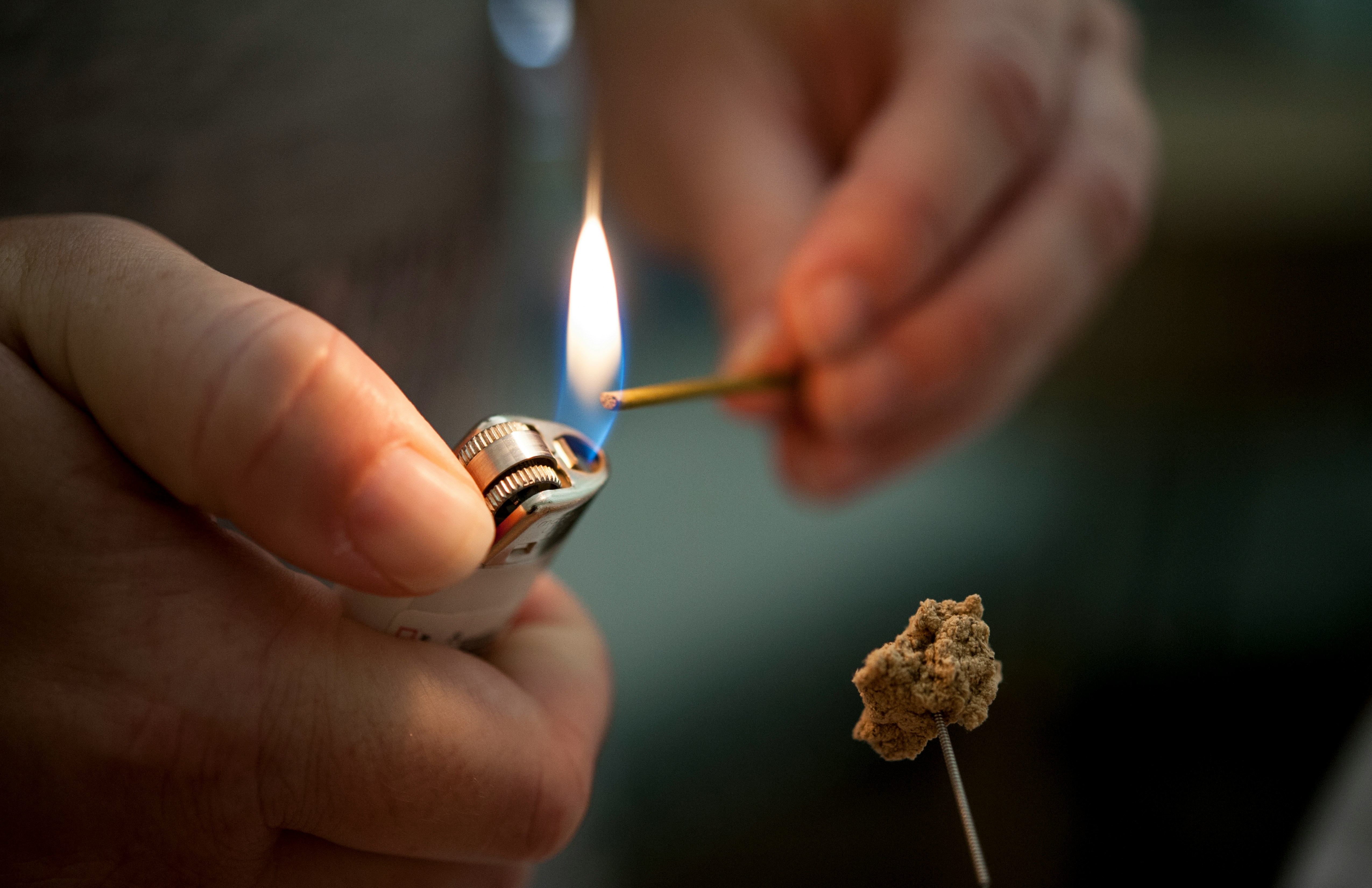 person holding lighted lighter with fire