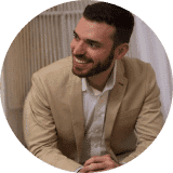 A man in a suit smiling