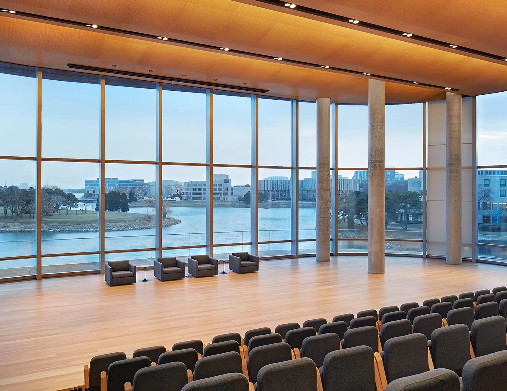 Main school auditorium with glowing wood ceiling and views of Lake Michigan