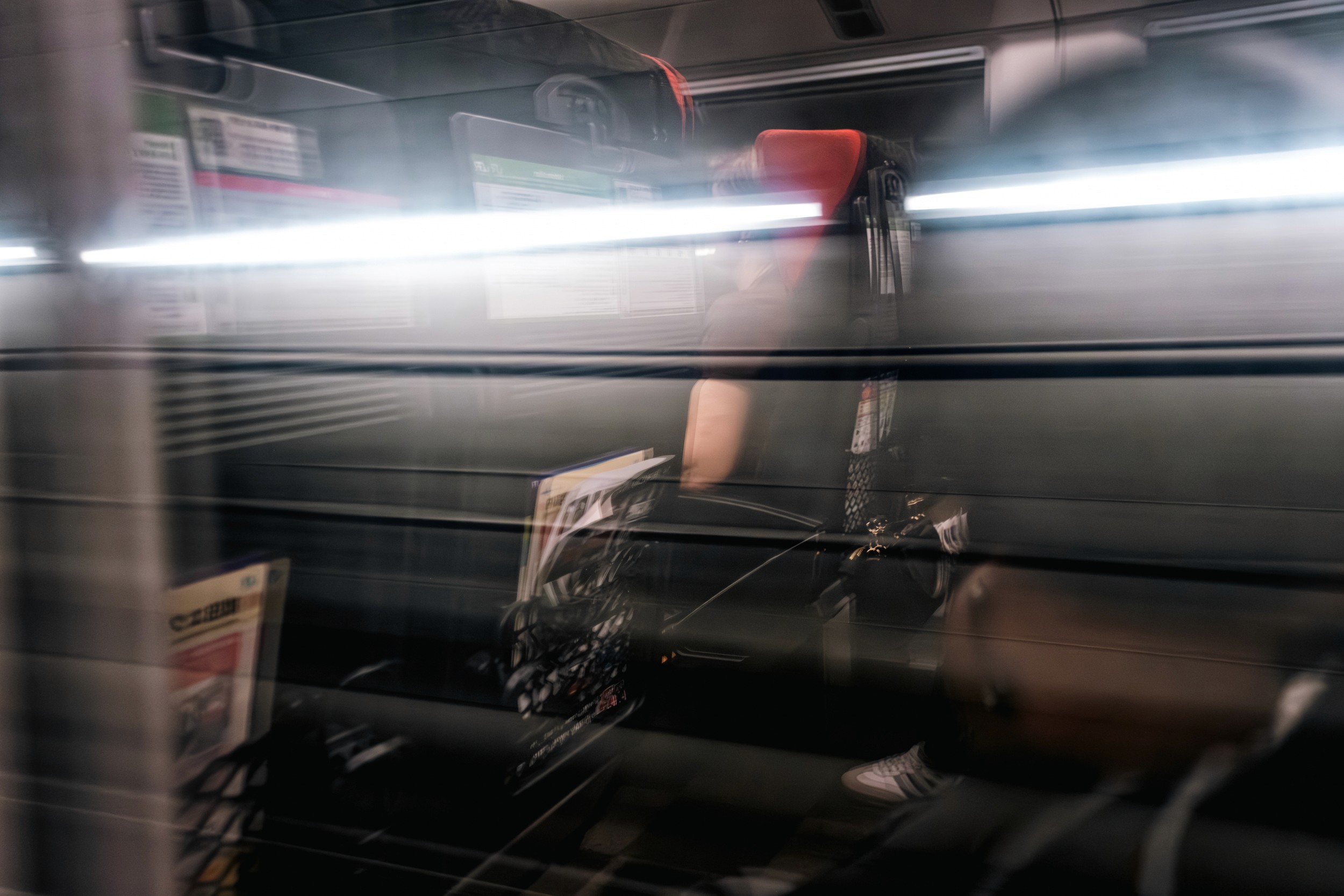 A dimly lit industrial setting with machinery and equipment blurred in the background.