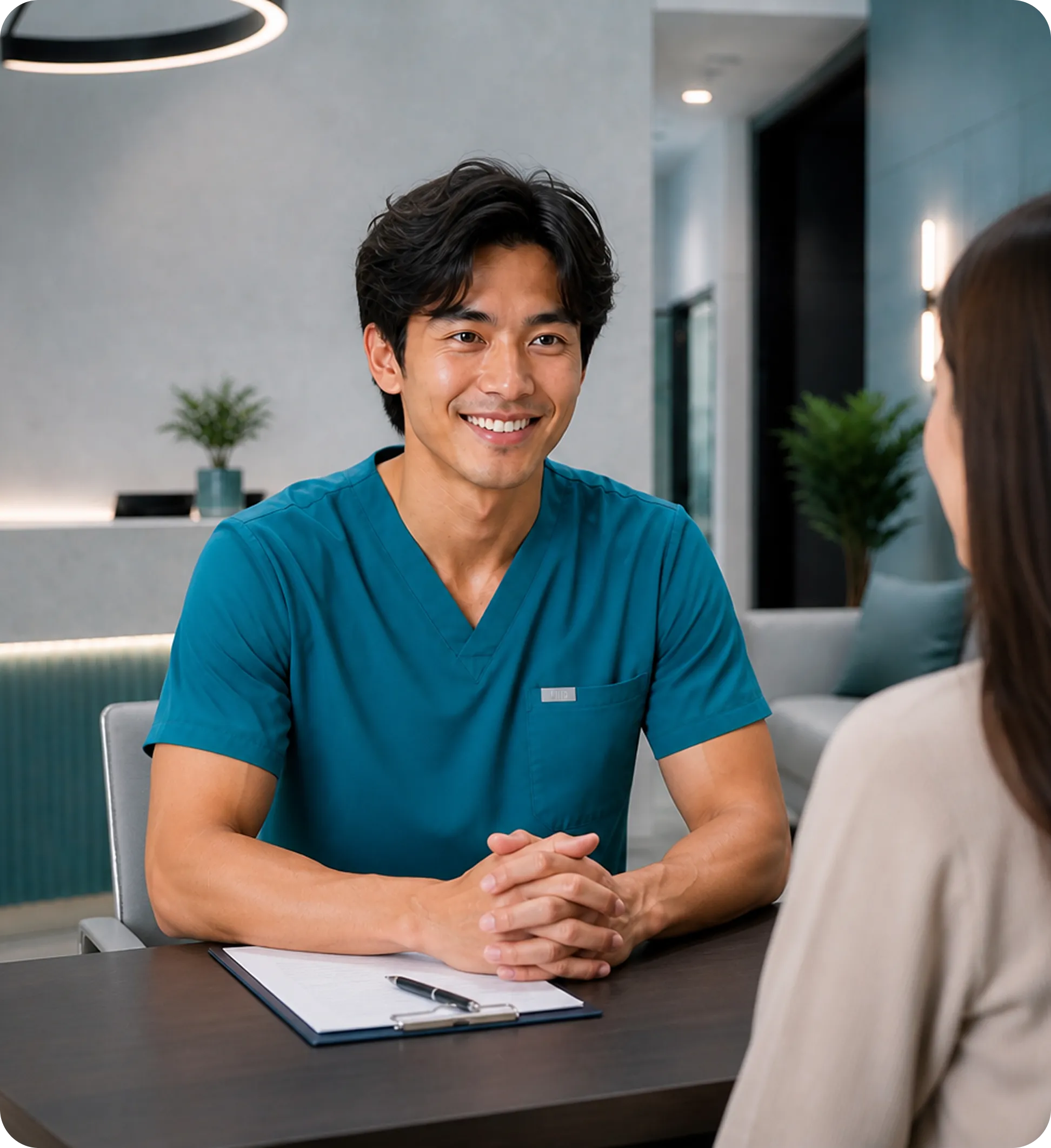 Male dentist showing patient teeth scan on hand-held mirror or display.