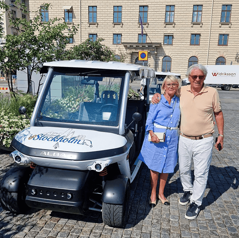 Tourists exploring Stockholm during private electric sightseeing cart tour