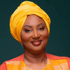 Man sitting against blue wall.