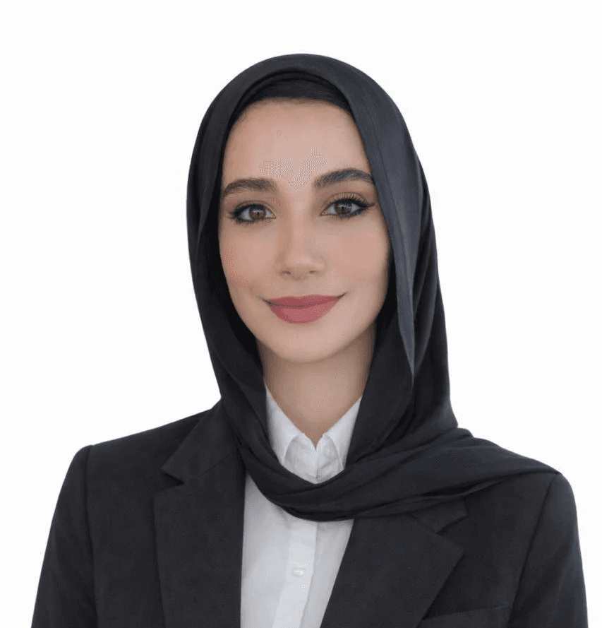 a woman with long brown hair smiling at the camera