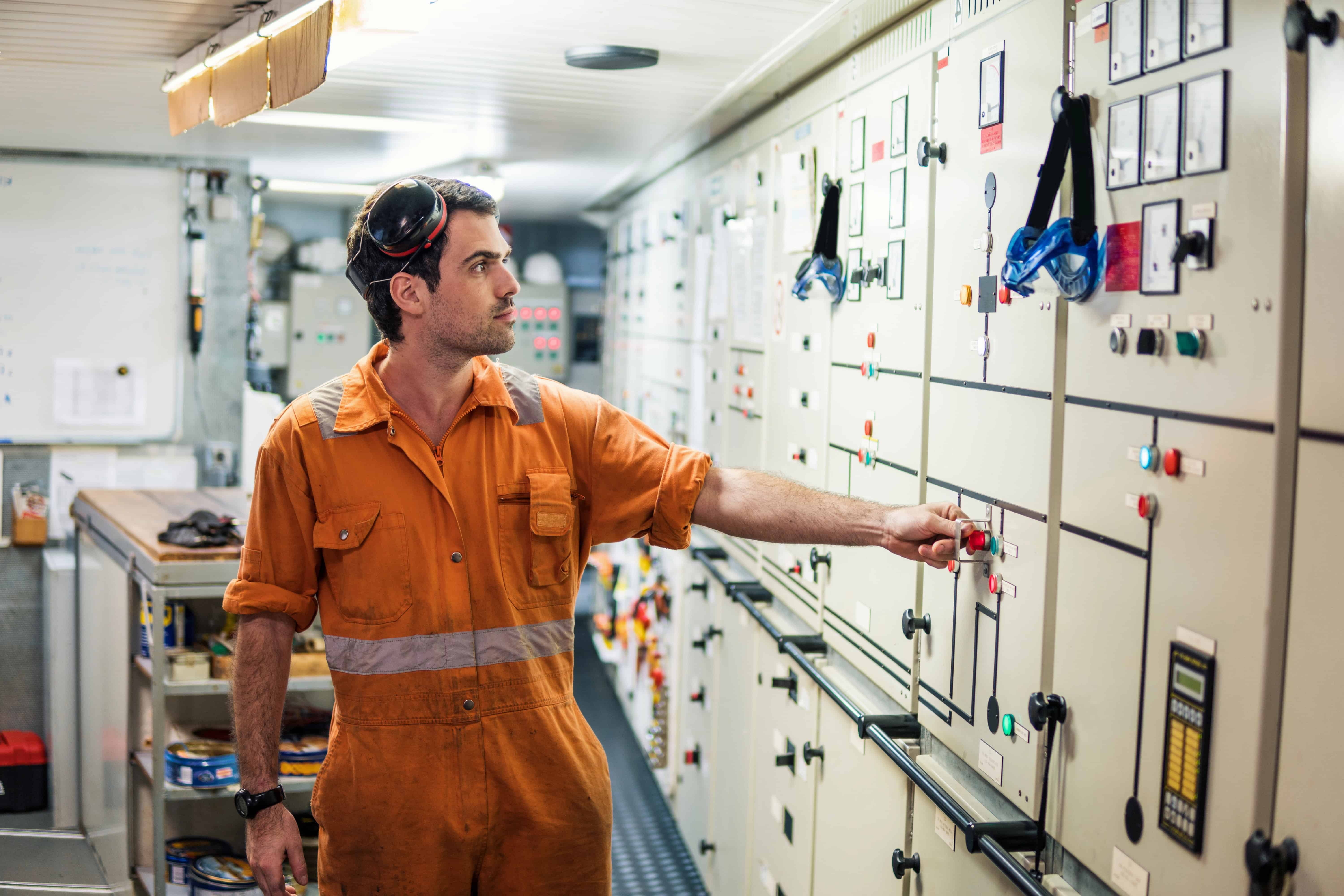 Engineer performing checks in the engine room to ensure machines are running smoothly
