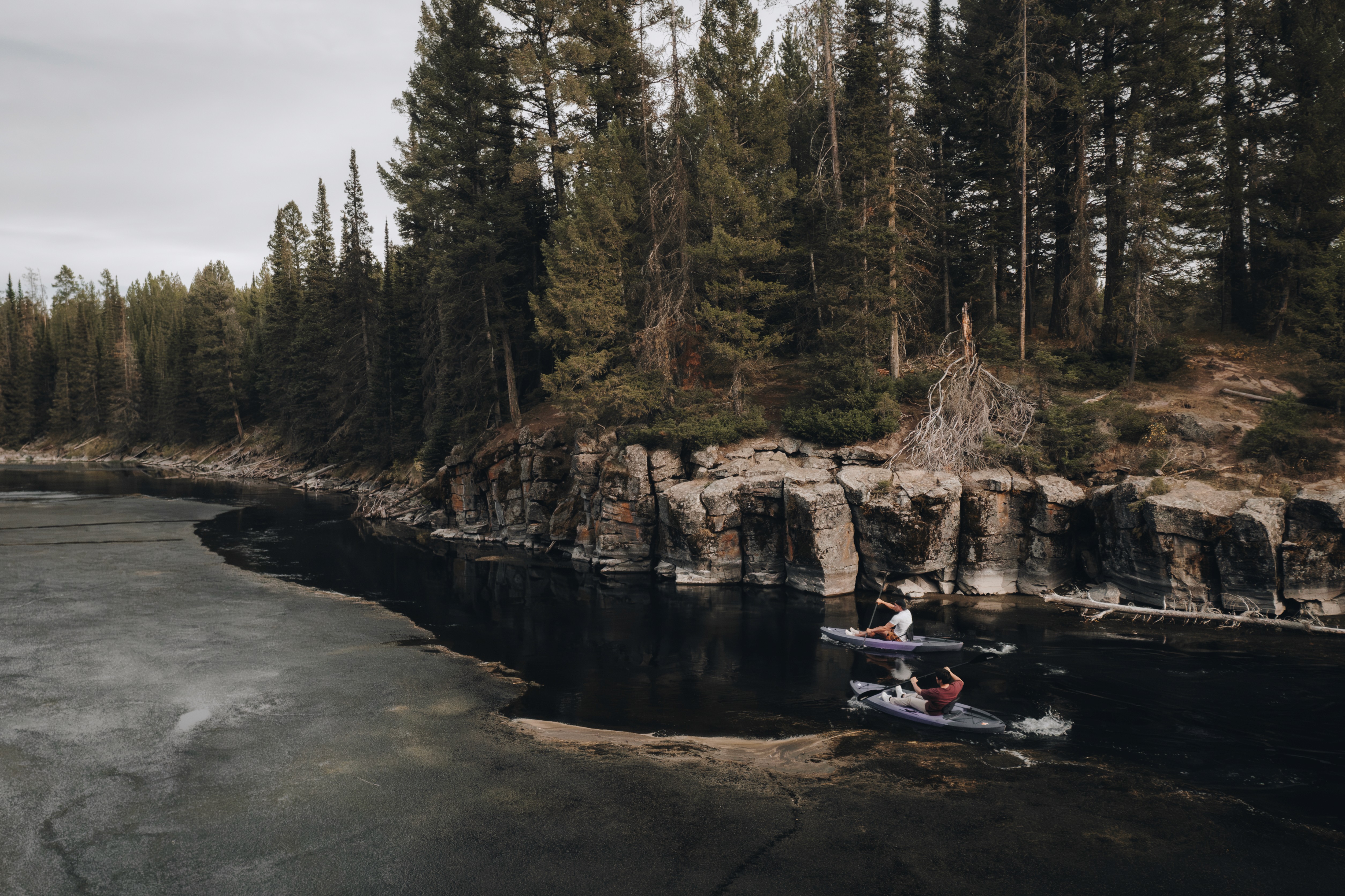 woman on kayak on body of water holding paddle