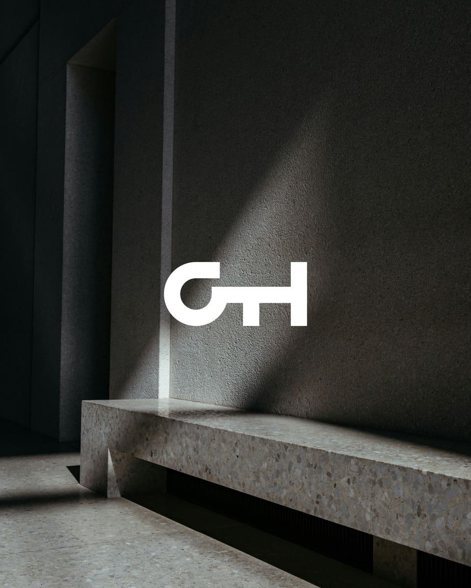 Grupo Hispano logo on top of an photo of an architectural space.