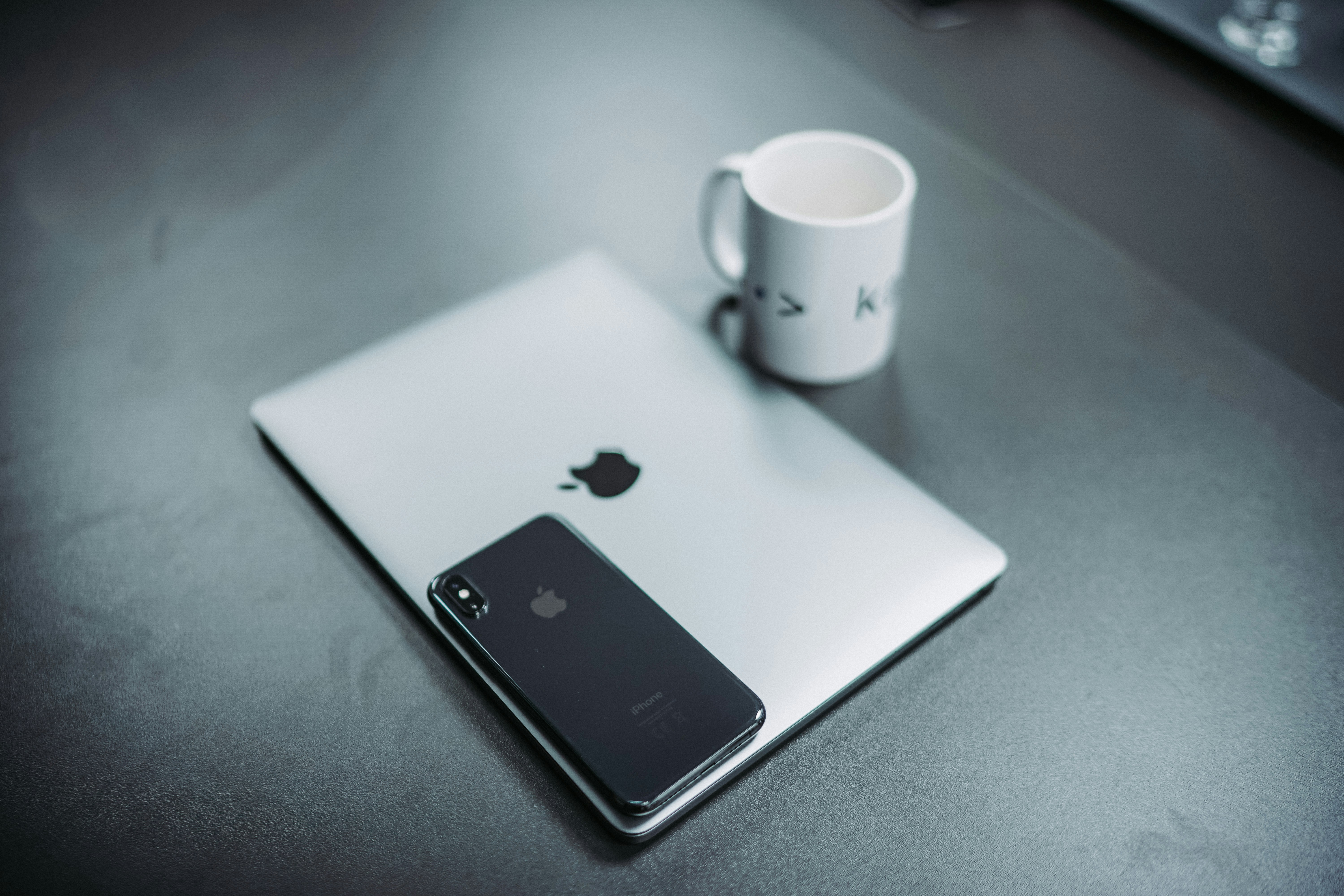 MacBook and white mug
