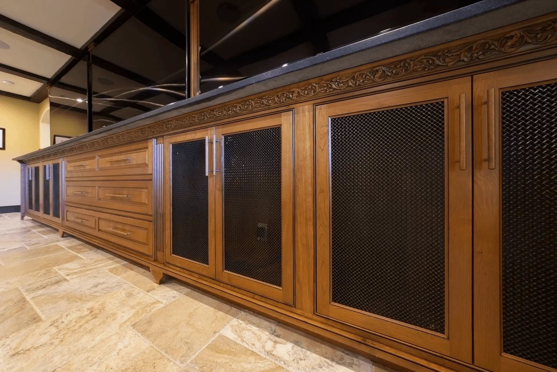 Wide shot of the entertainment room, displaying custom cabinetry and the multi-TV wall setup, for the ultimate entertainment experience in the San Juan Capistrano project. Photo by Todd Huge.