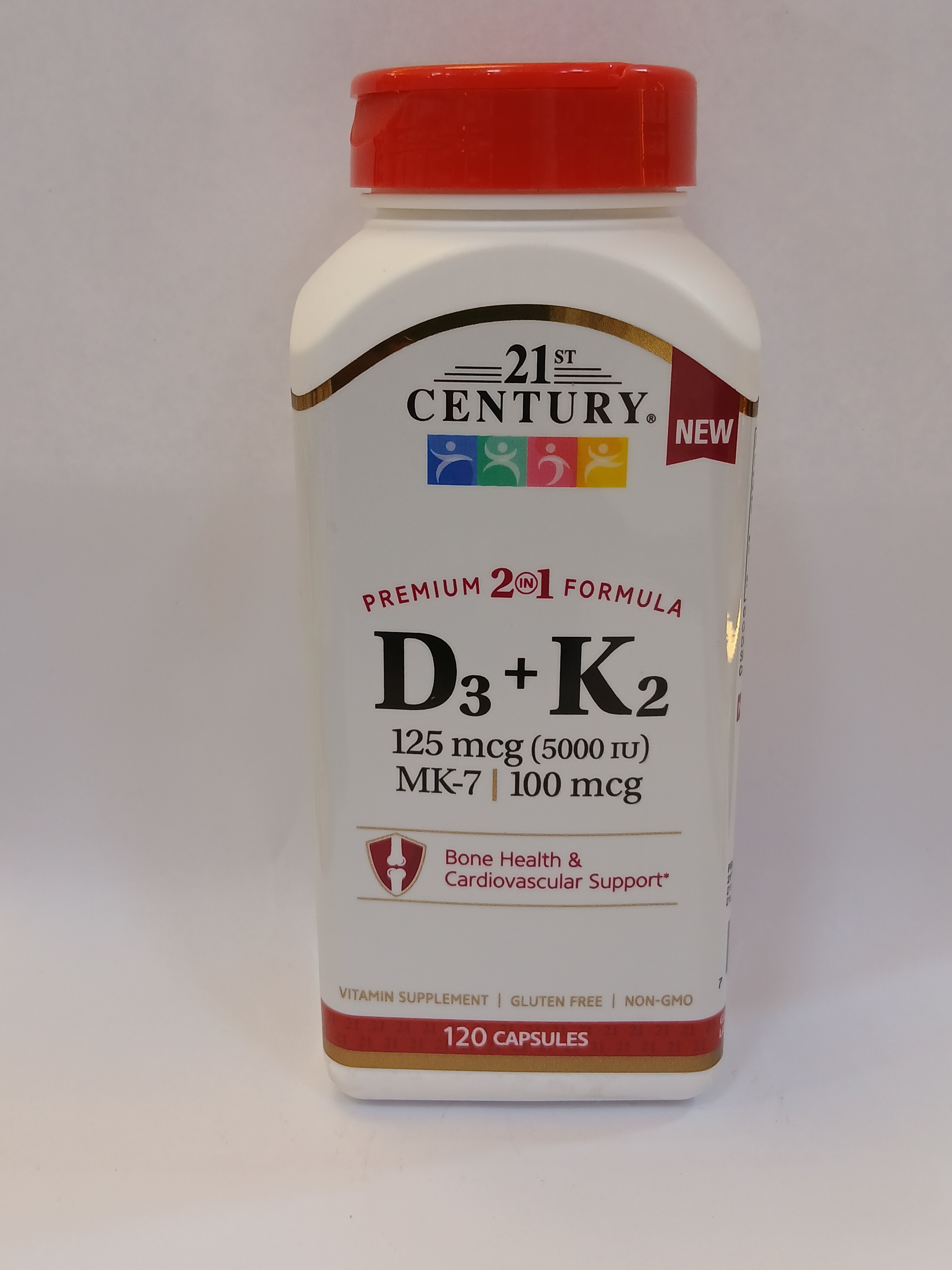 A white plastic bottle with a red cap displays a colorful label featuring text indicating a vitamin supplement containing 120 capsules, and highlights bone and cardiovascular support.
