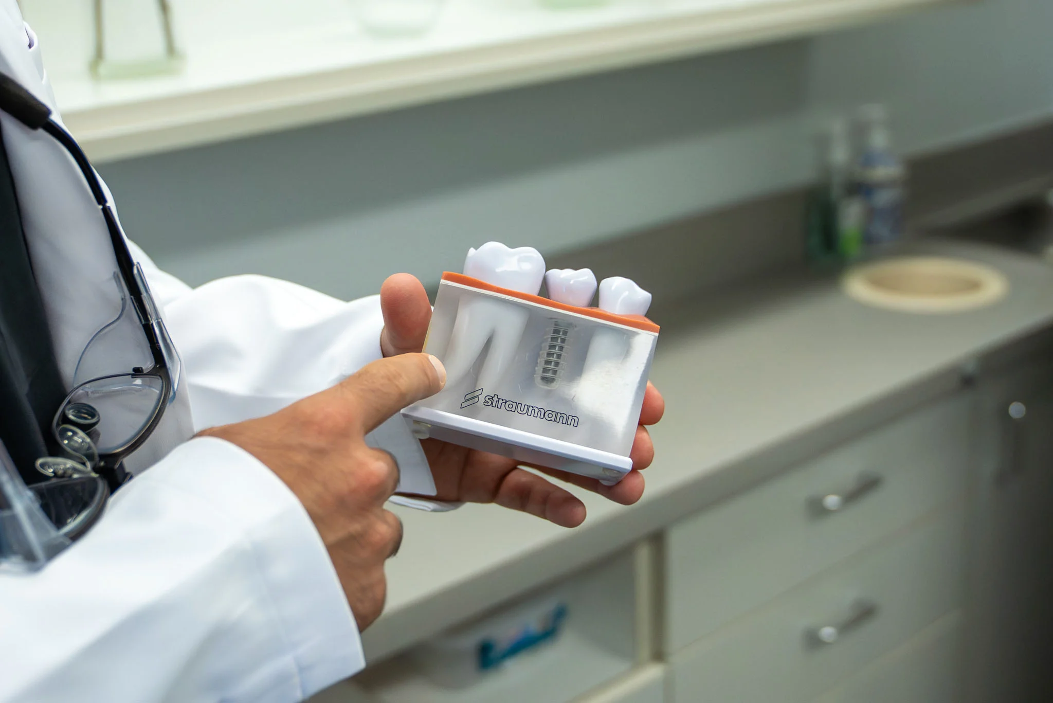 Dental implant model displayed during a consultation at an oral surgery practice in Fresno, CA