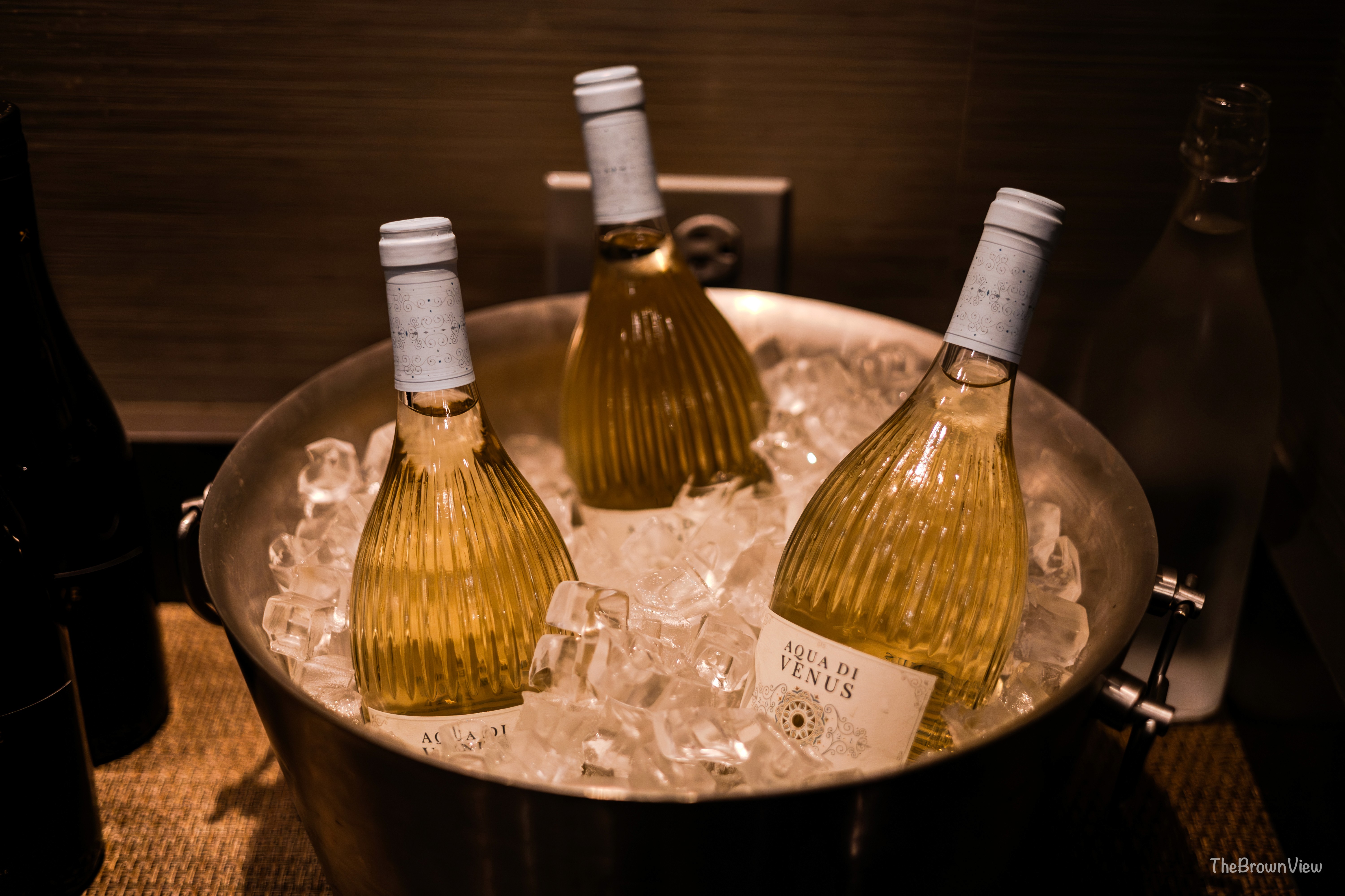 Corporate event photography in Chicago featuring chilled bottles of Aqua di Venus white wine on ice.