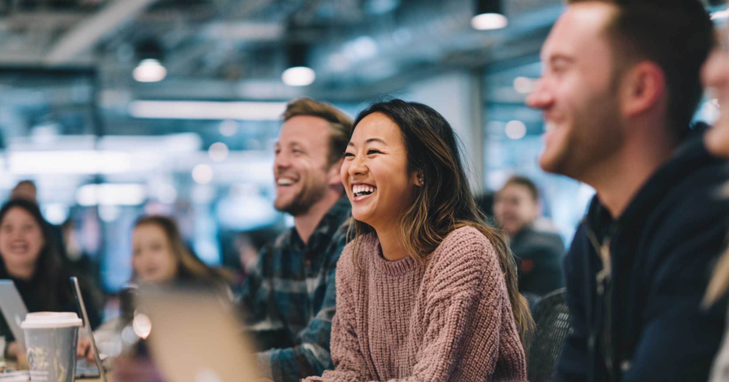 Young people in an office smiling and laughing