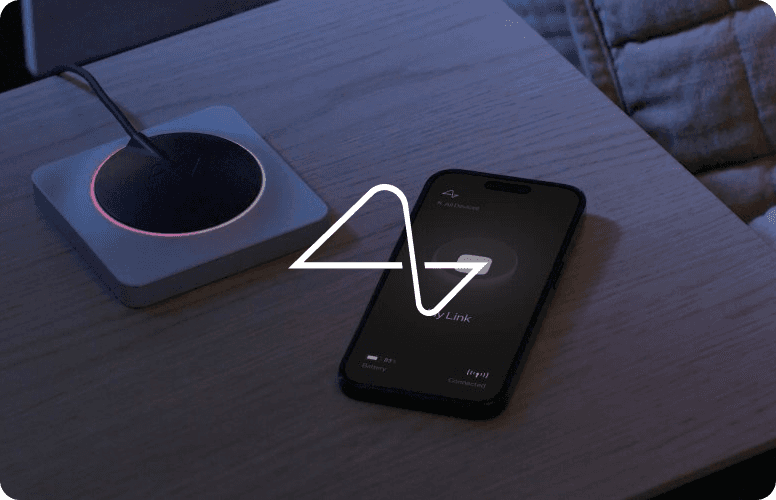 A red hot air balloon glows at sunset over mountains.