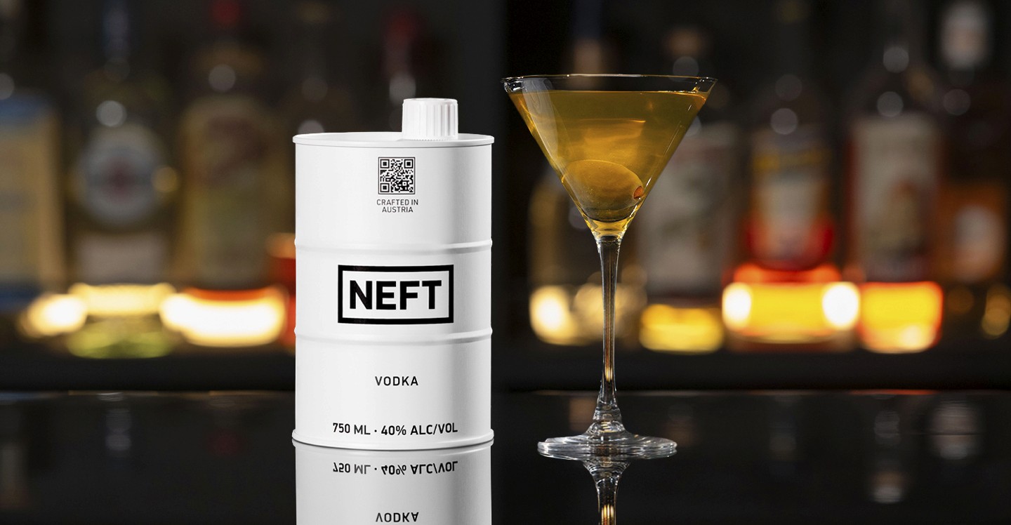 A NEFT Barrel and a glass of Dirty Martini on a bar counter.